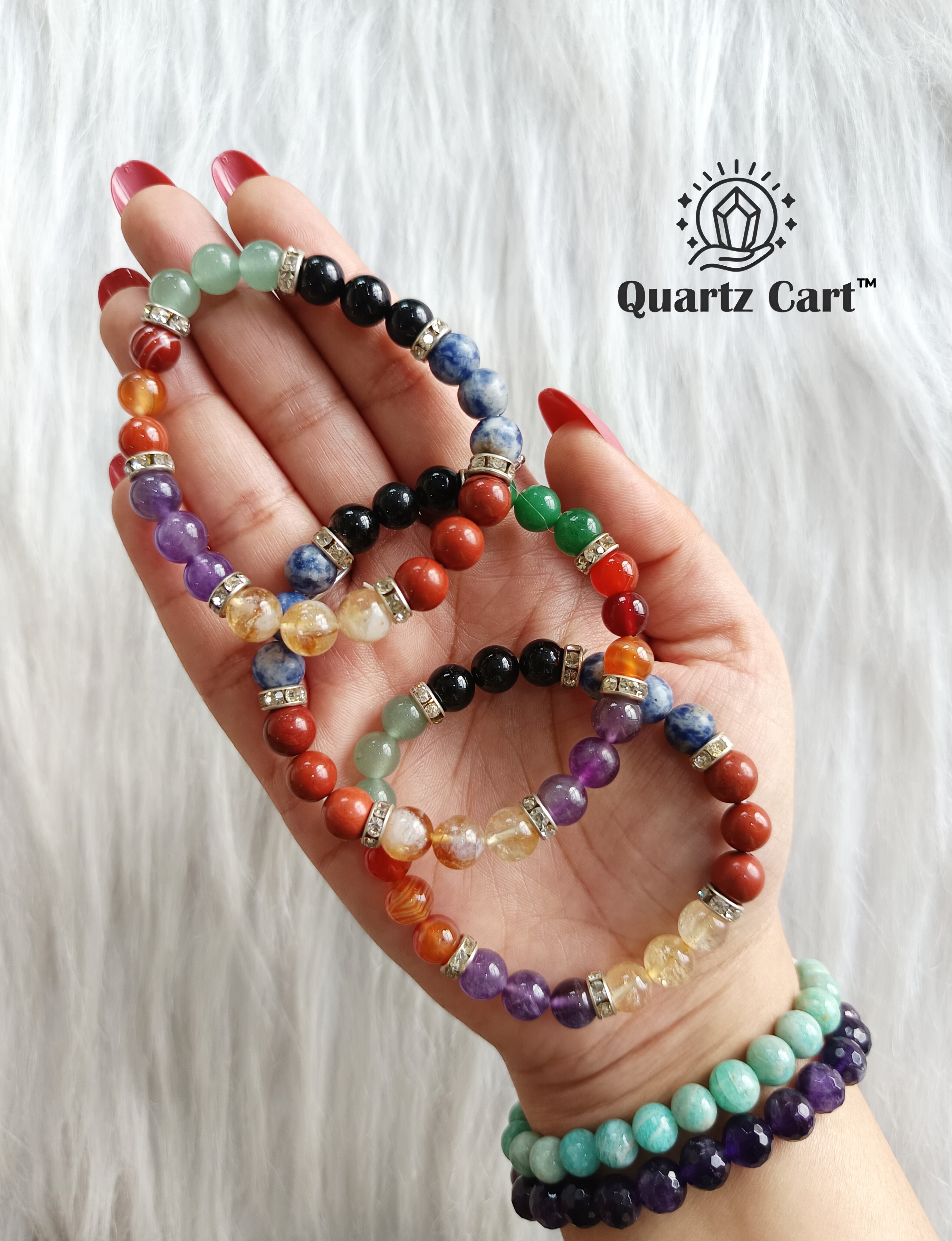 Hand holding colorful 7 chakra healing crystal bracelets for energy balance spiritual growth and chakra alignment