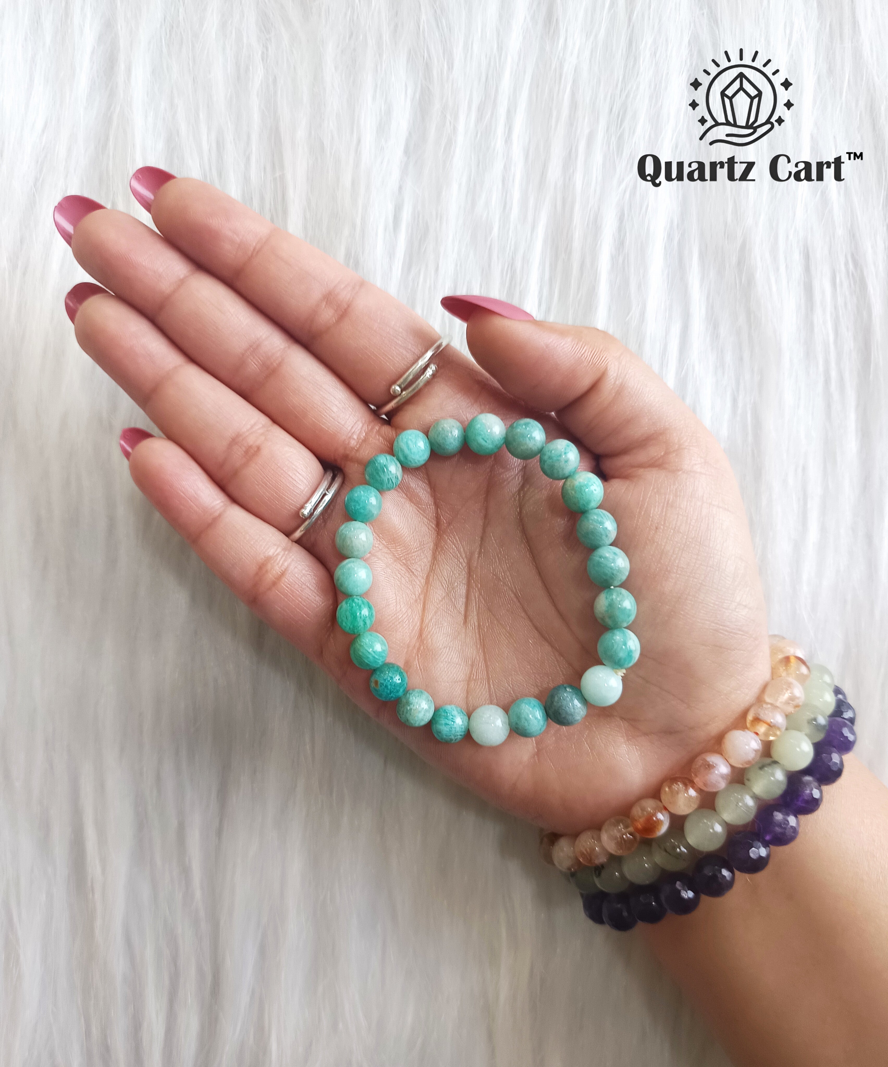 Amazonite bracelet displayed on surface with natural green gemstone beads, crystal bracelet for emotional balance and stress relief