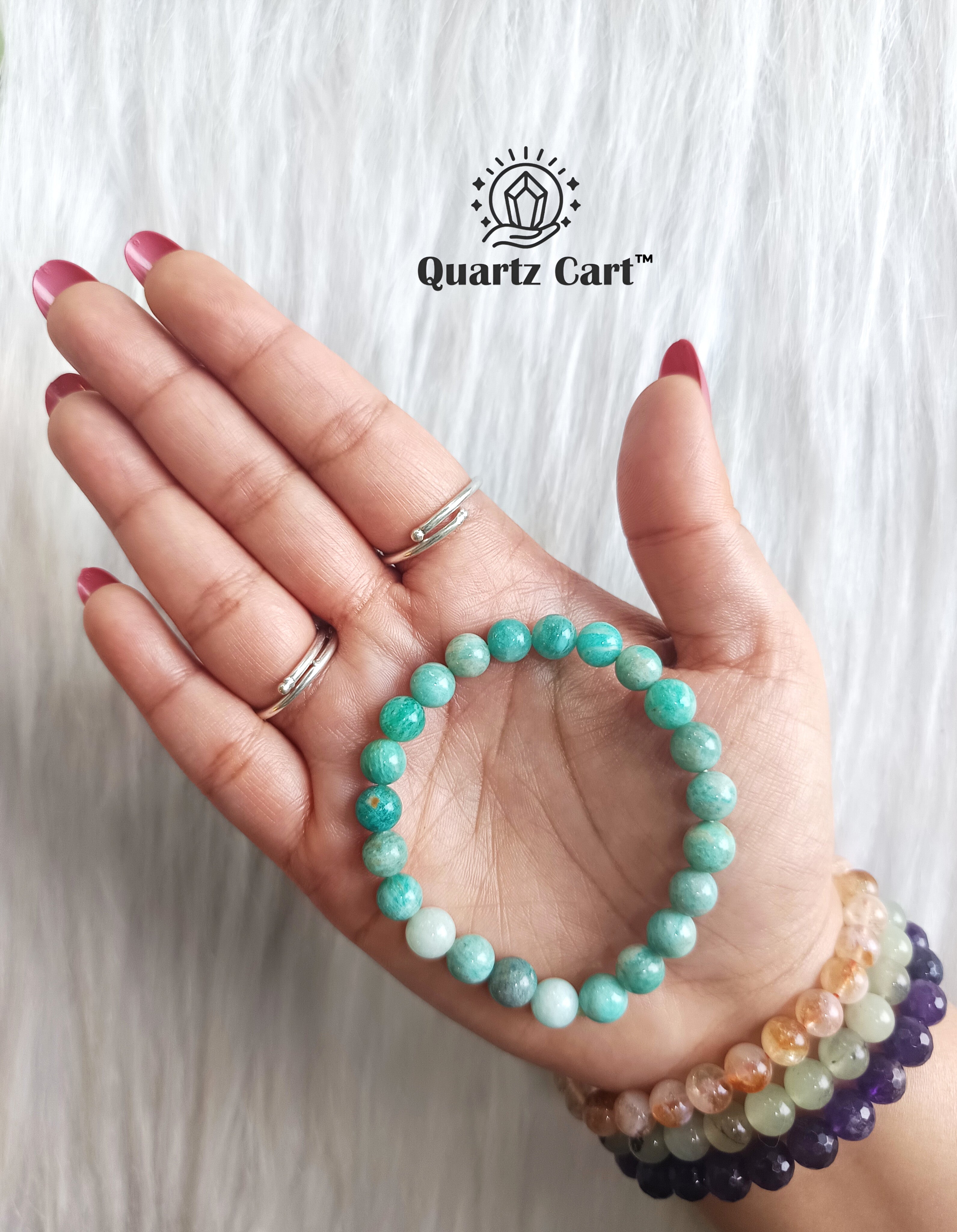 Amazonite bracelet worn on hand showing polished green gemstone beads, healing crystal bracelet for calm mind and harmony