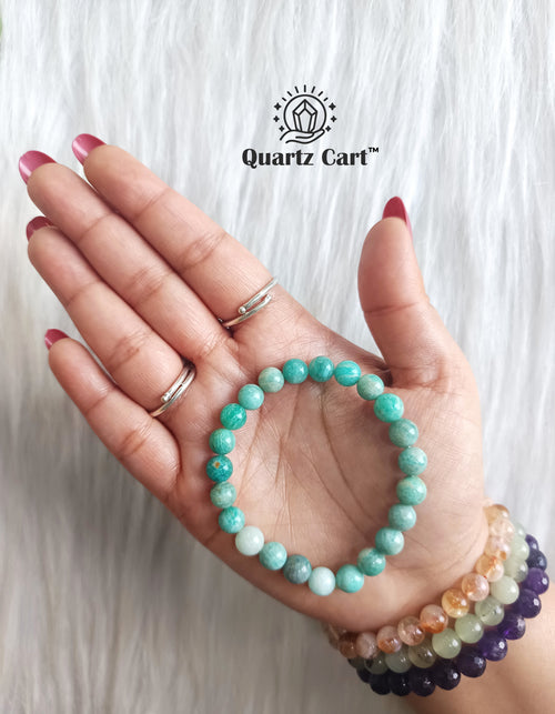Amazonite bracelet worn on hand showing polished green gemstone beads, healing crystal bracelet for calm mind and harmony