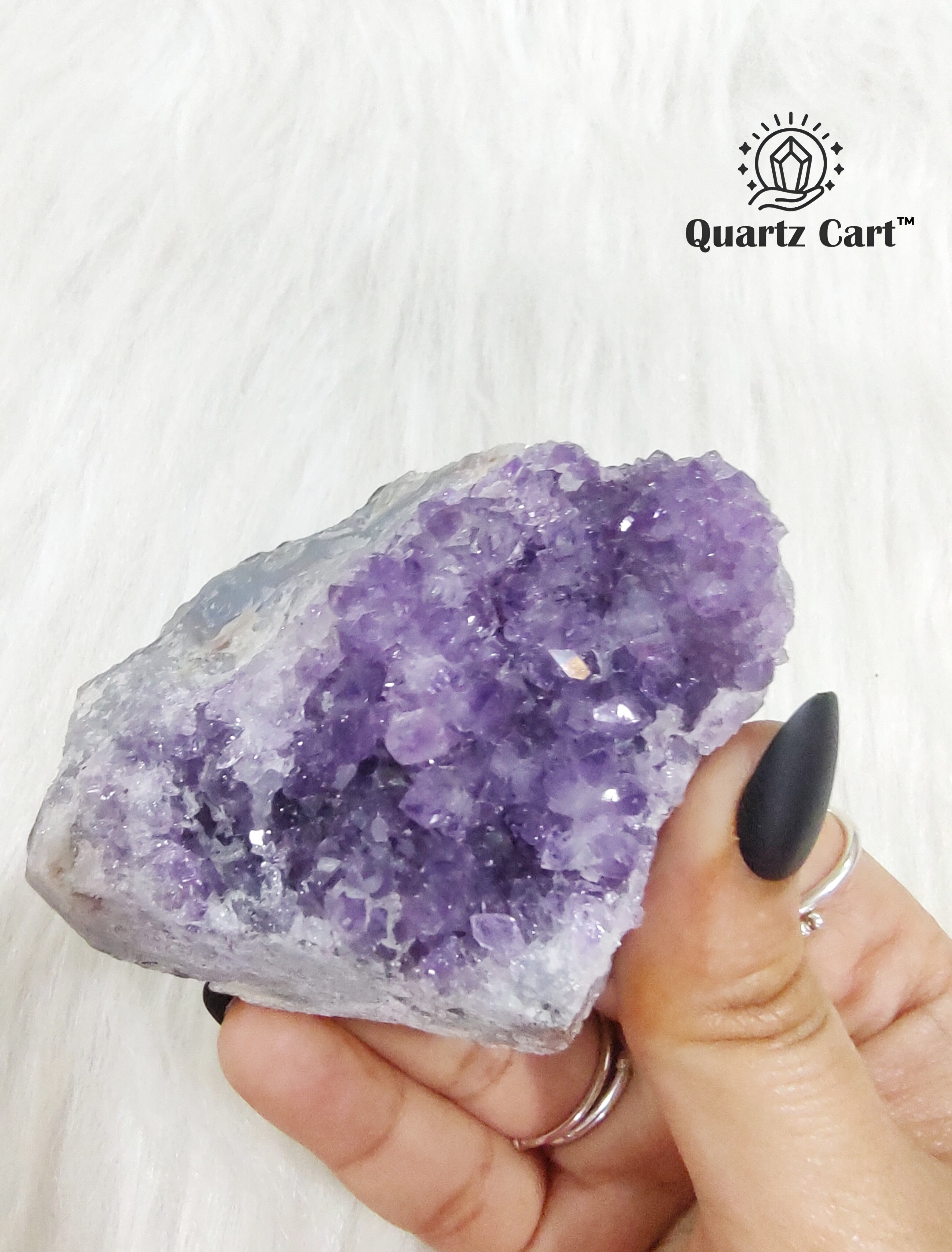 Natural Amethyst crystal cluster medium #03 held in hand showing raw purple crystal points for meditation and spiritual healing.