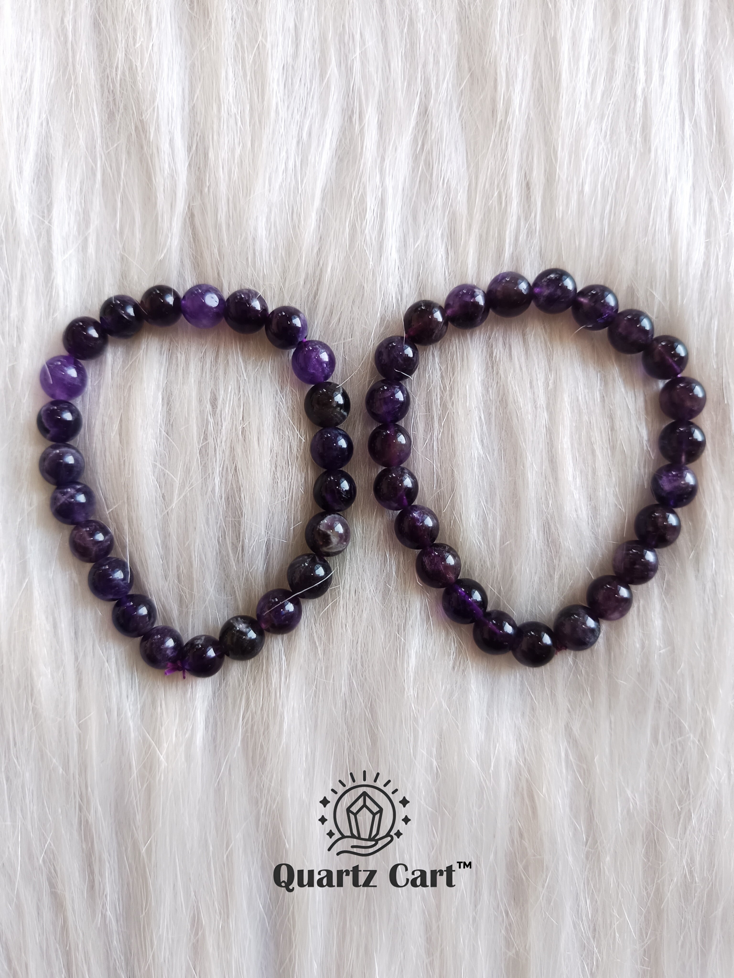 Hand wearing Amethyst round healing crystal bracelet for peace protection and emotional balance