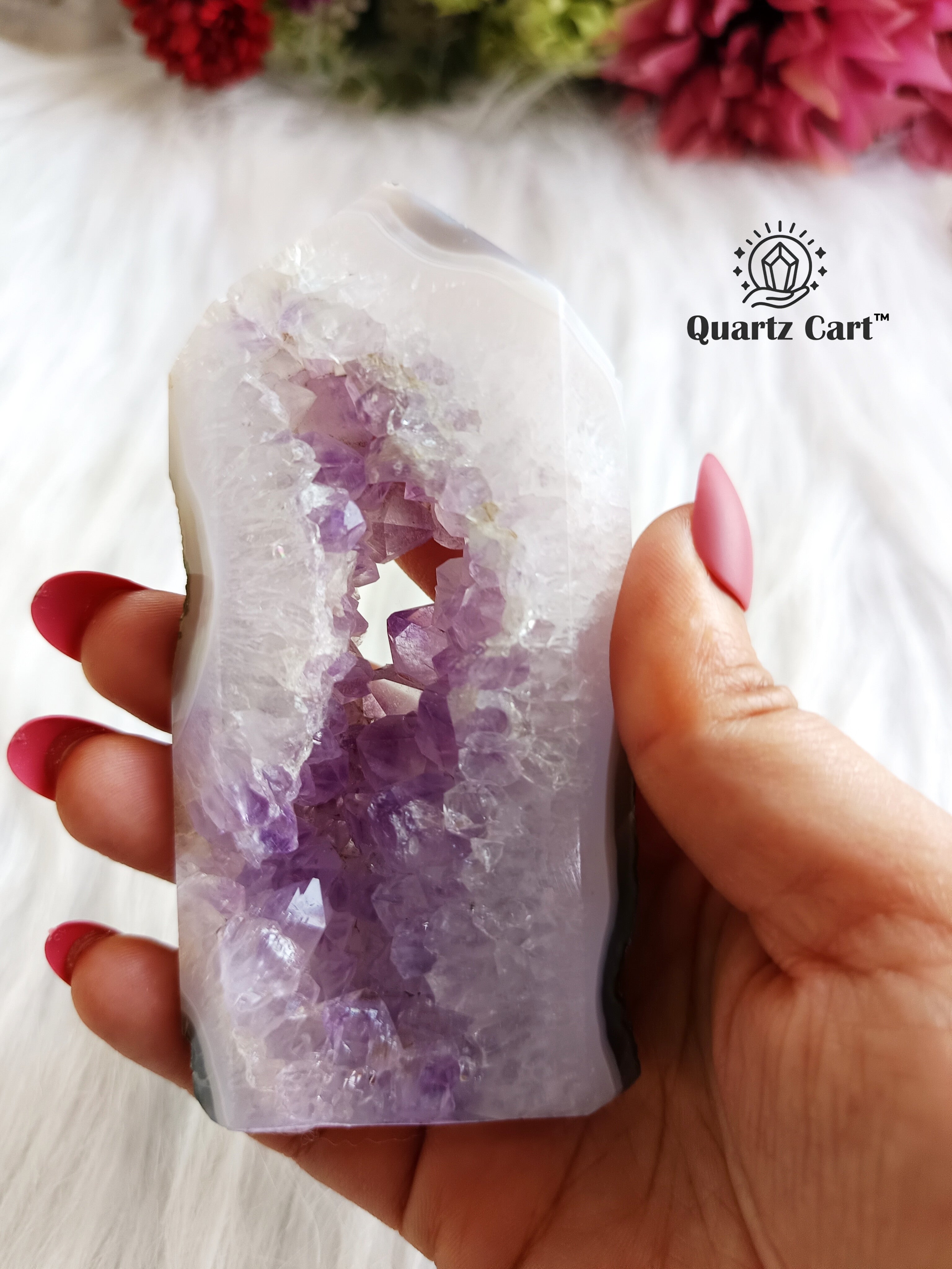 hand holding amethyst tower cluster decorative stone