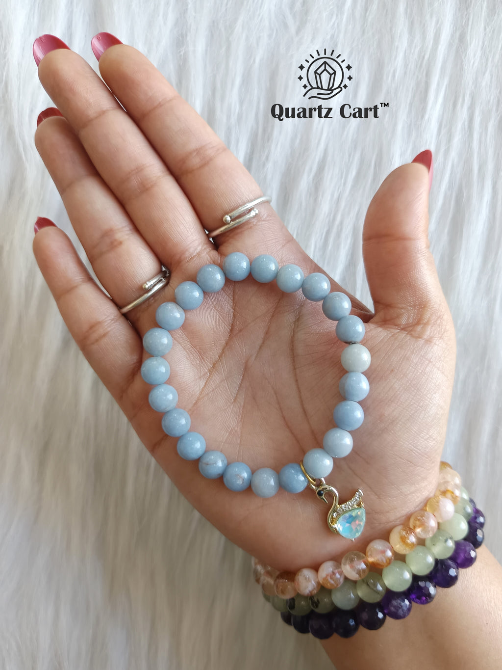 angelite charms bracelet worn on hand for calm peace and emotional healing