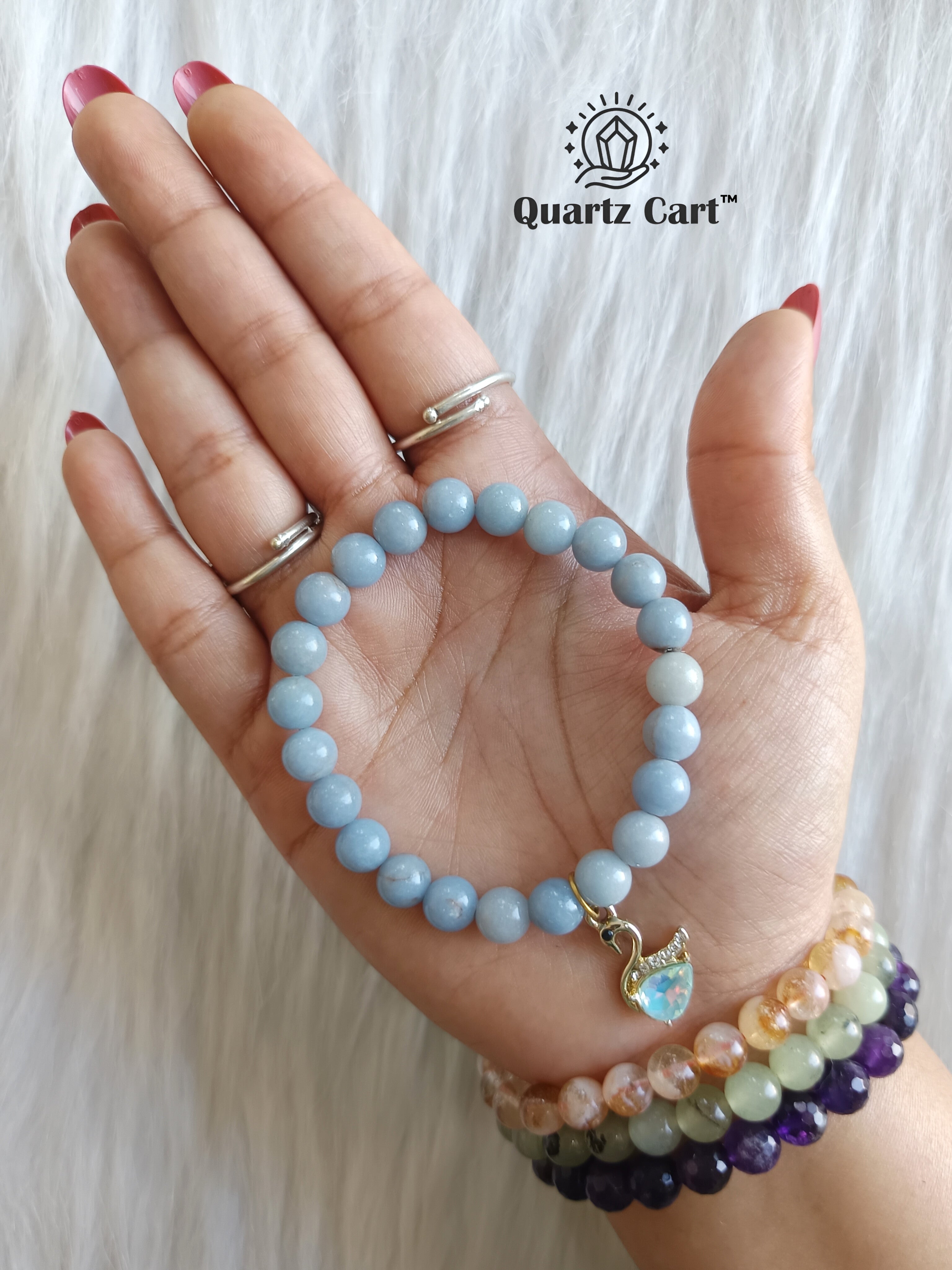 angelite charms bracelet worn on hand for calm peace and emotional healing