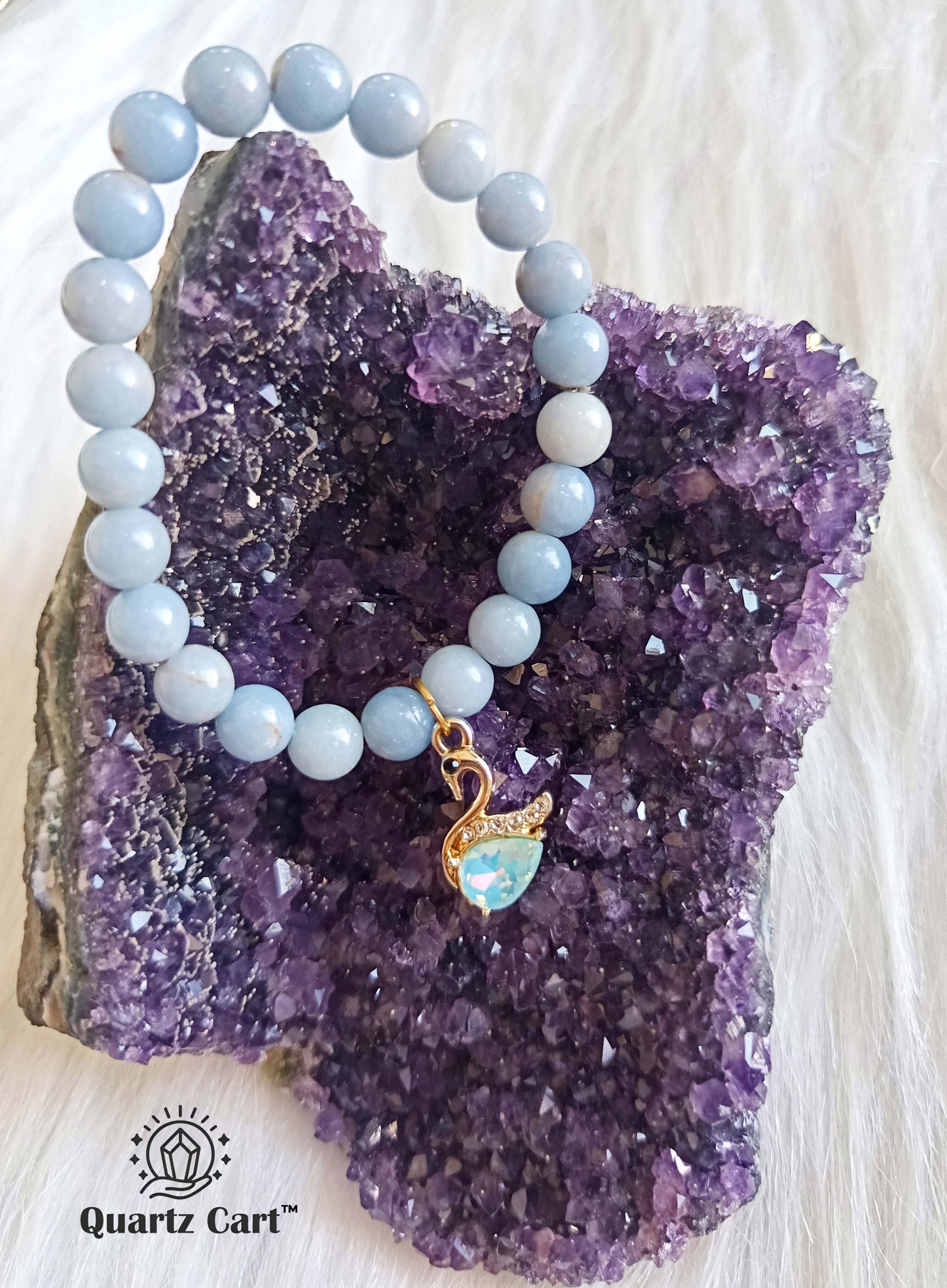 angelite charm bracelet placed on crystals showing healing energy and spiritual vibe