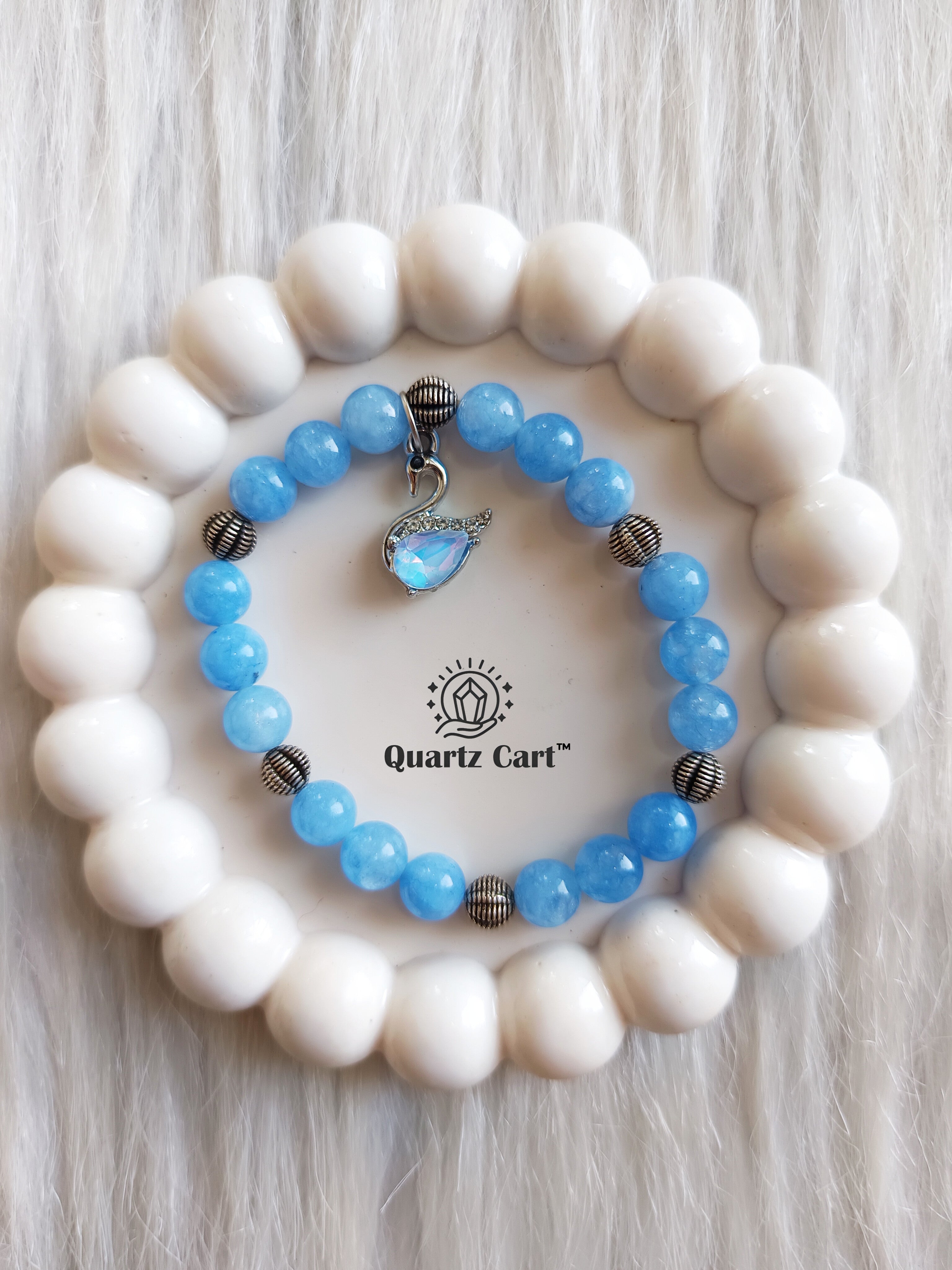 Aquamarine charms bracelets displayed on surface showing light blue gemstone beads, healing crystal bracelet for calmness and emotional balance