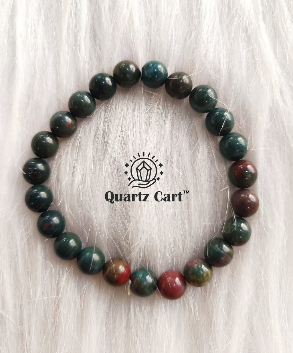 Bloodstone round bracelet displayed on soft surface showing green and red natural gemstone beads, healing crystal bracelet for strength and protection