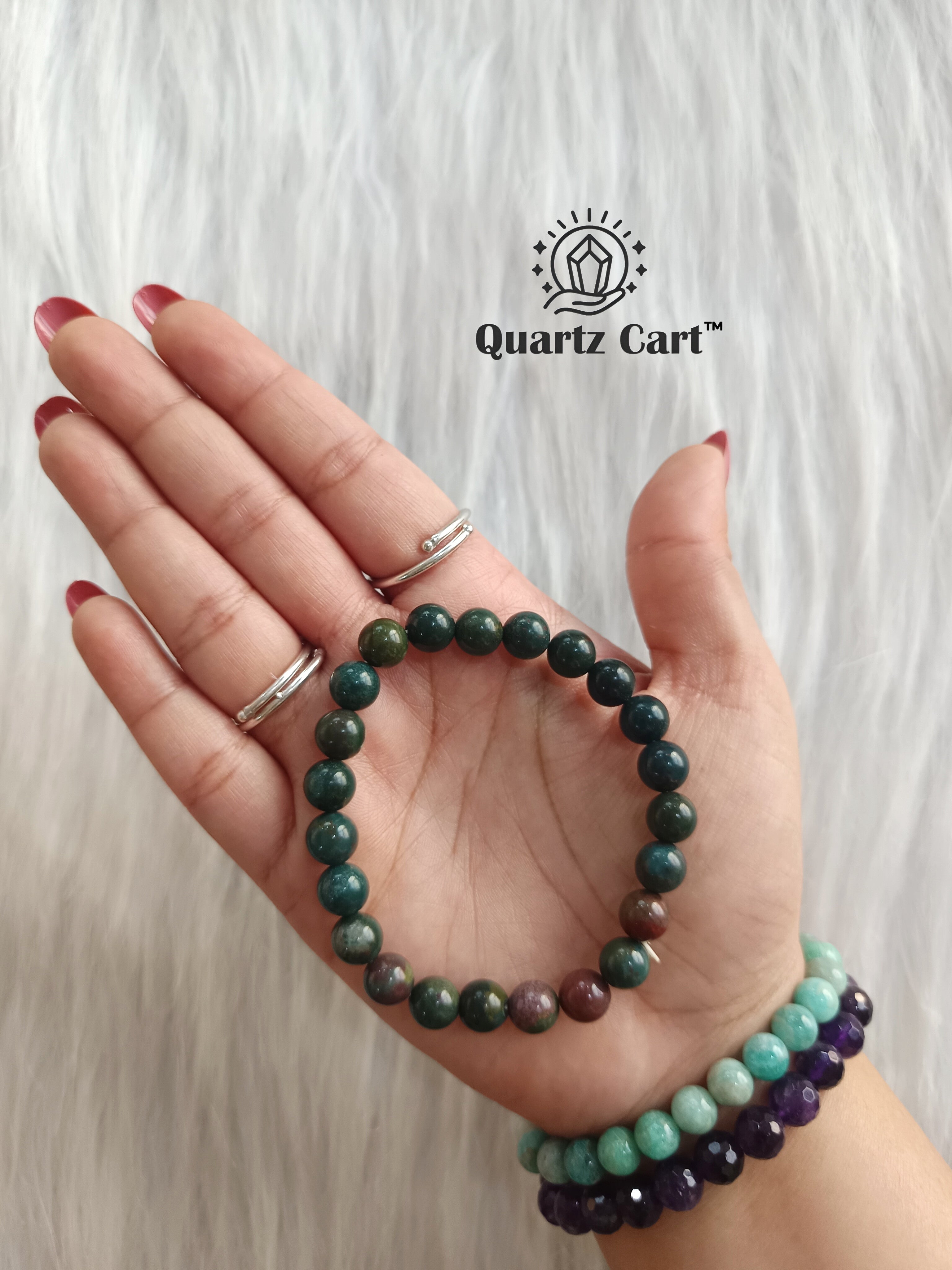 Bloodstone round bracelet worn on hand showing natural green and red gemstone beads, crystal bracelet for courage, vitality and energy