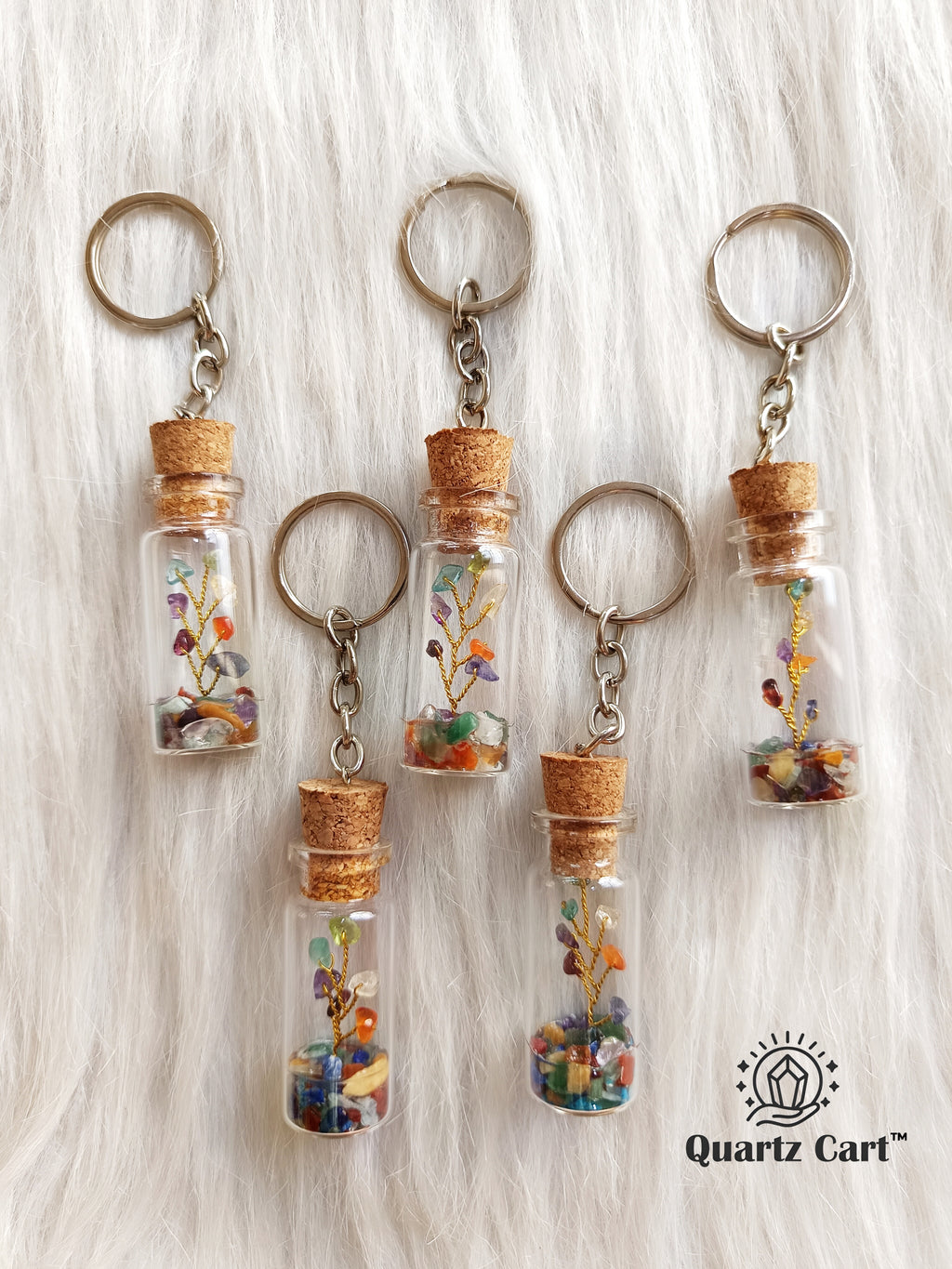 color stone bottle keychains with metal rings hanging together