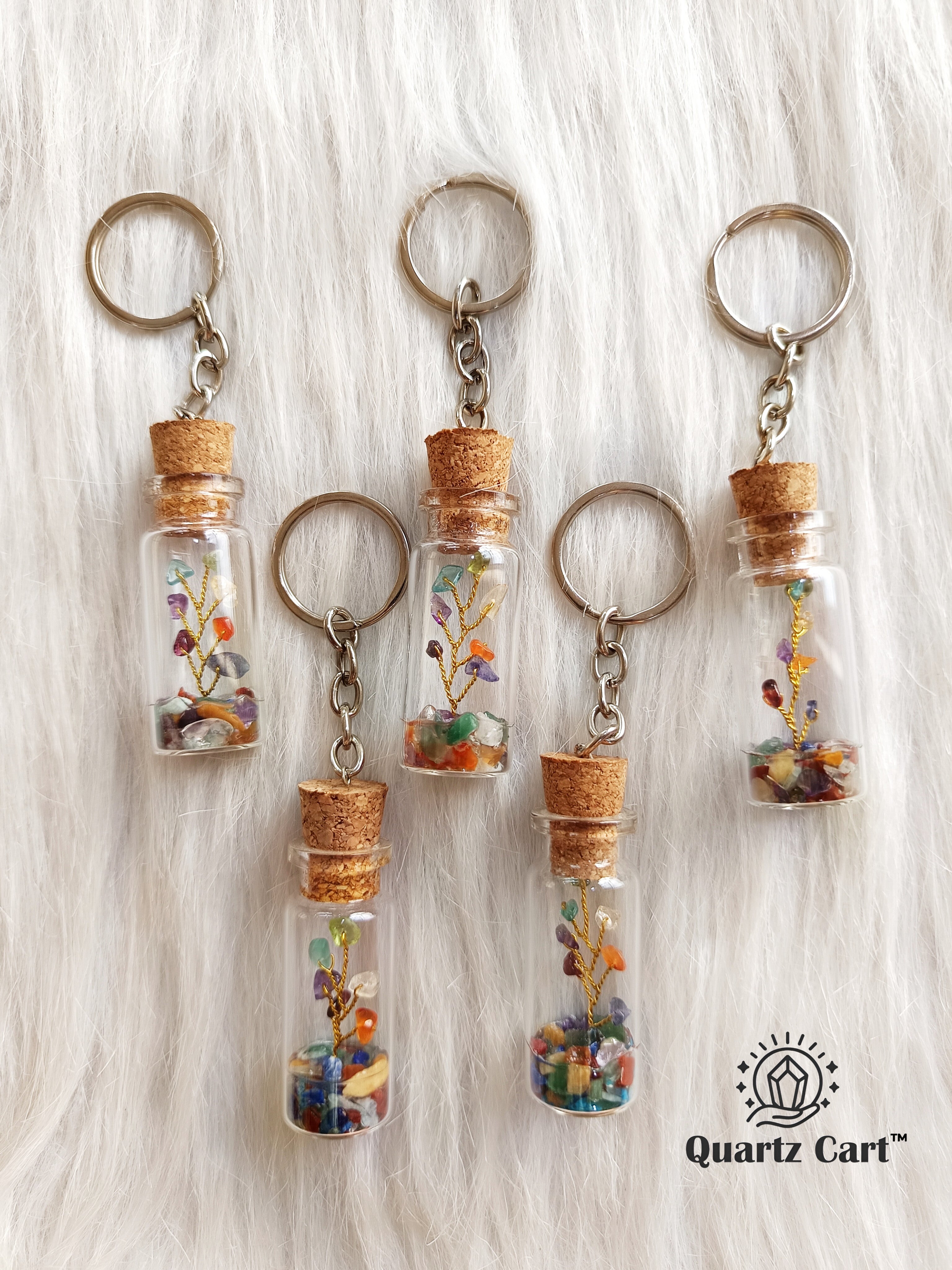 color stone bottle keychains with metal rings hanging together