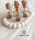 glass bottle keychain filled with colorful stone chips