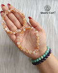Hand holding Citrine healing crystal bracelet 8mm for wealth prosperity confidence and positive energy
