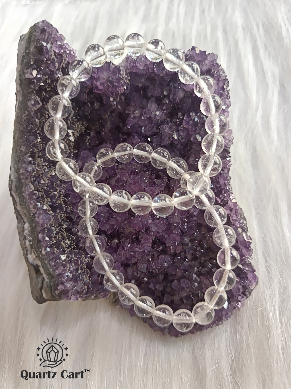 Two clear quartz bracelets displayed on crystal surface, natural gemstone bracelets for spiritual growth, healing and energy balance