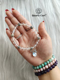 Clear quartz faceted charms bracelet worn on hand displaying sparkling crystal beads and charm, gemstone bracelet for clarity, focus and energy healing