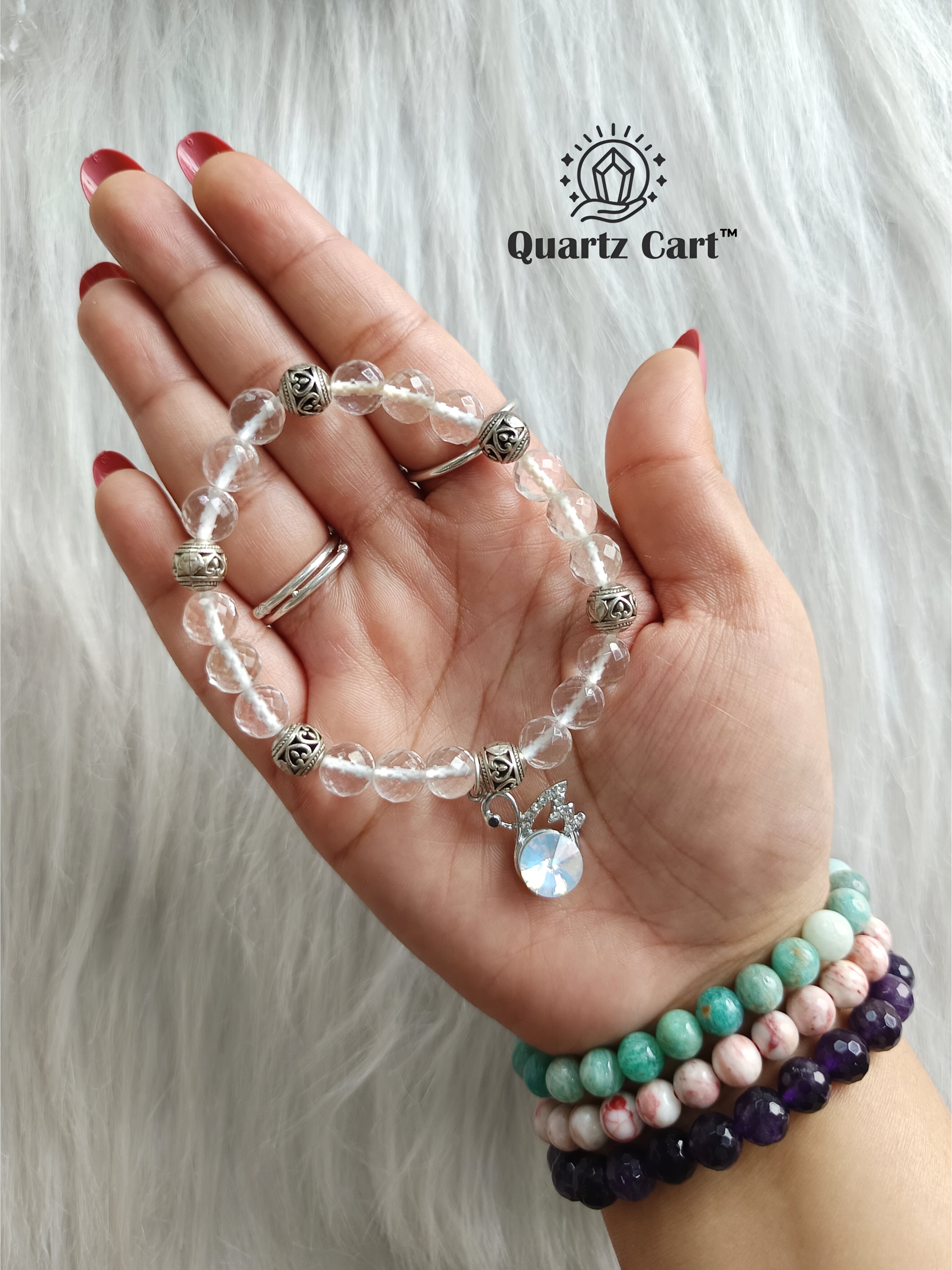 Clear quartz faceted charms bracelet worn on hand displaying sparkling crystal beads and charm, gemstone bracelet for clarity, focus and energy healing