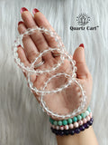 Hand holding Clear Quartz faceted healing crystal bracelets for clarity energy amplification and spiritual balance