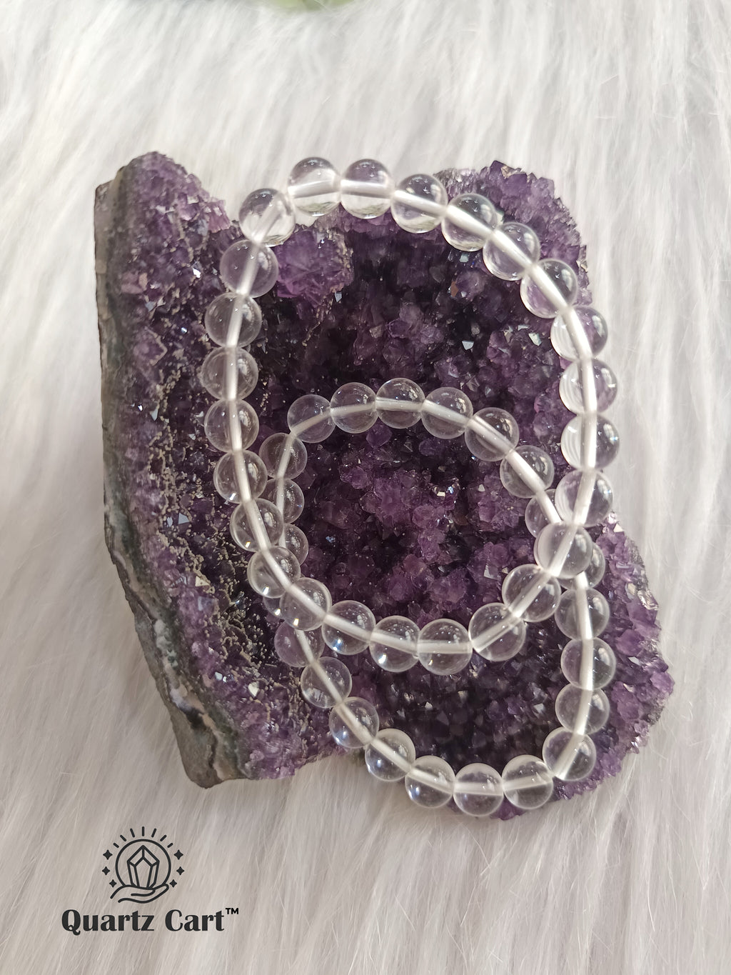 Clear Quartz gemstone bracelet displayed on crystal cluster symbolizing clarity healing and spiritual growth
