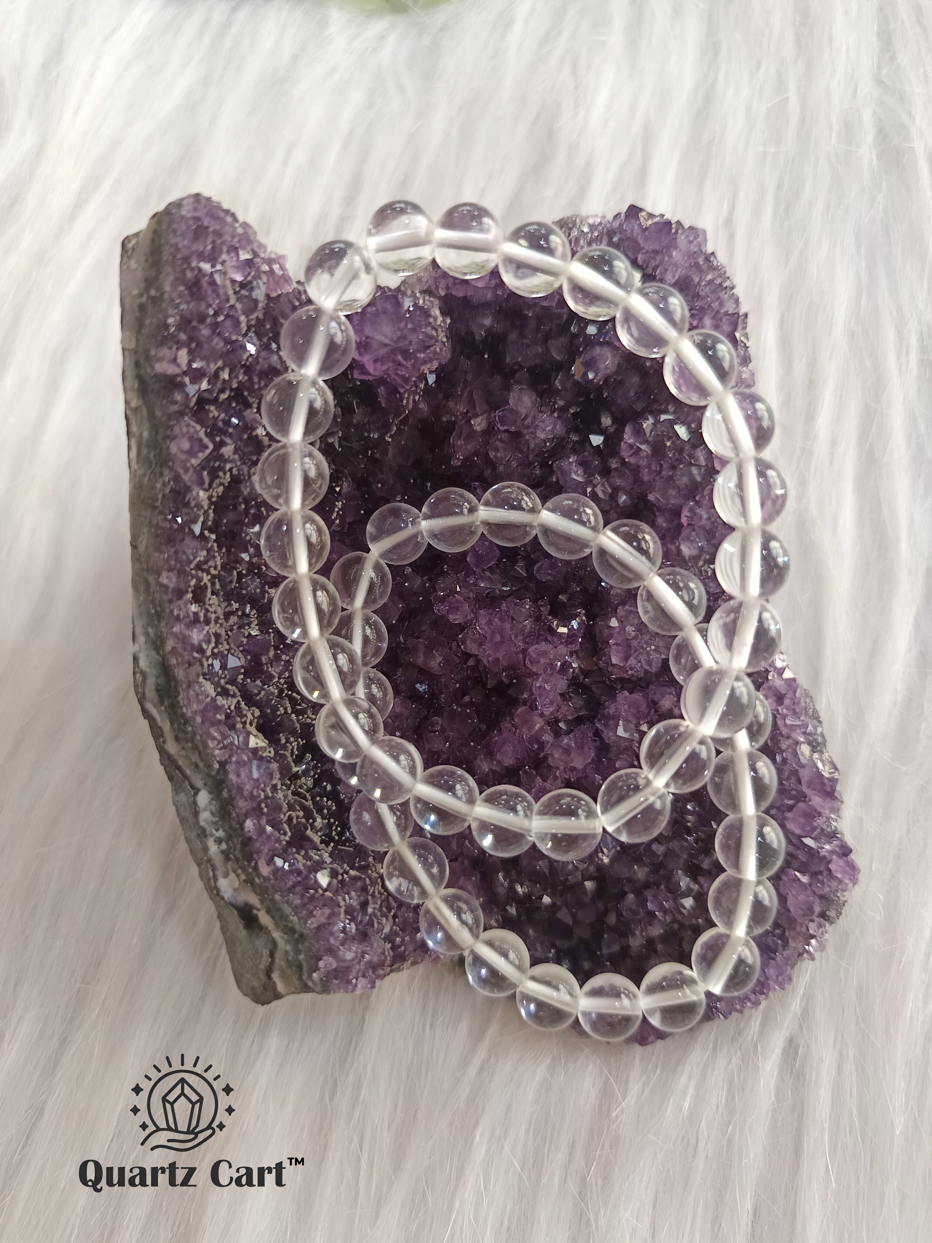 Clear Quartz gemstone bracelet displayed on crystal cluster symbolizing clarity healing and spiritual growth