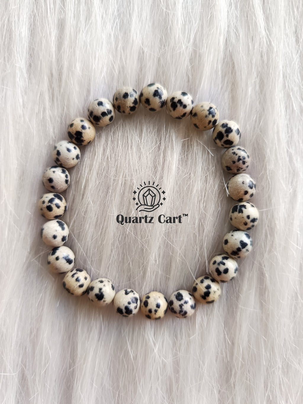Dalmatian Jasper bracelet worn on hand showing natural gemstone beads, perfect for stress relief, grounding and positive energy