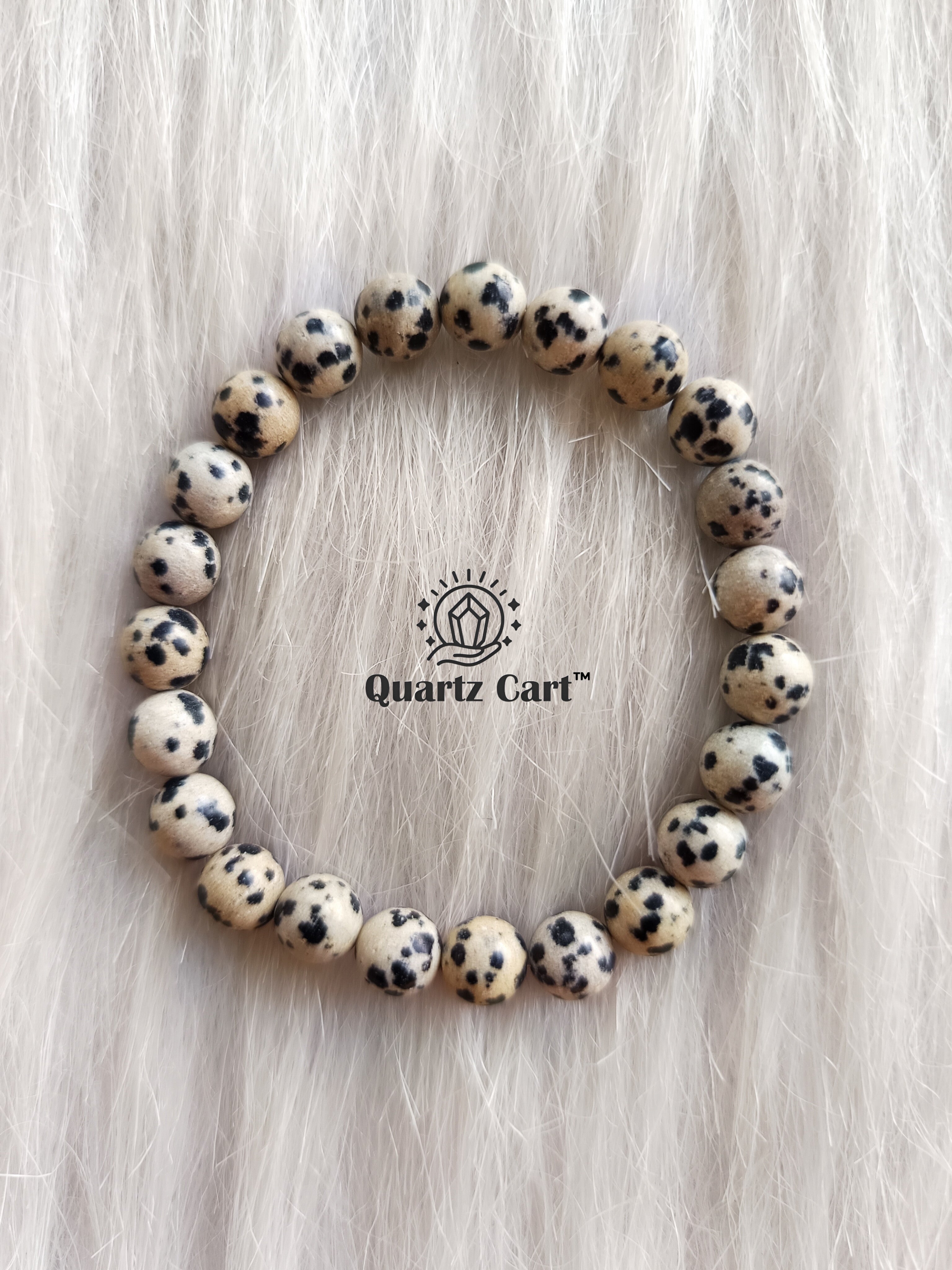Dalmatian Jasper bracelet worn on hand showing natural gemstone beads, perfect for stress relief, grounding and positive energy