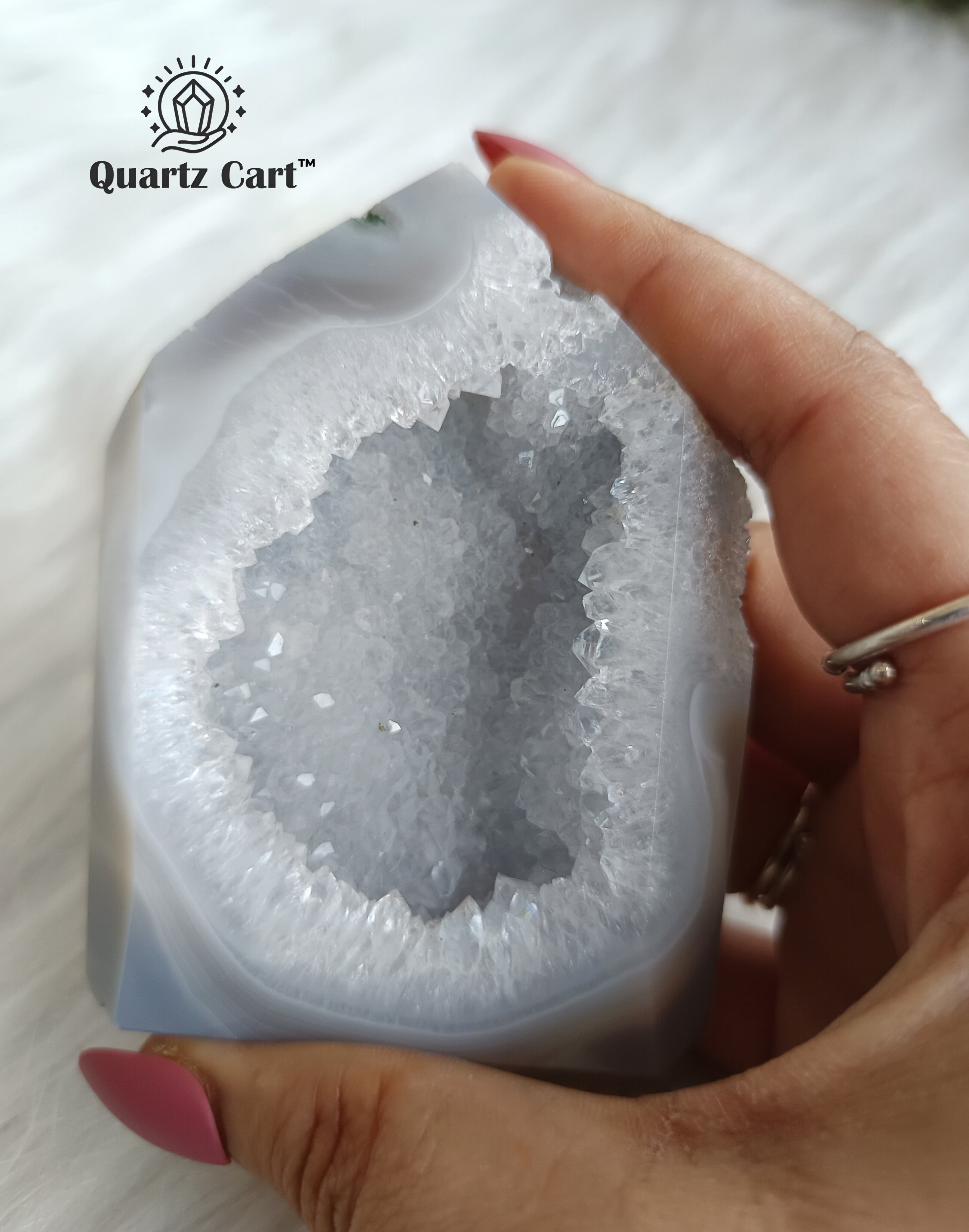 hand holding white druzy agate tower cluster decorative stone