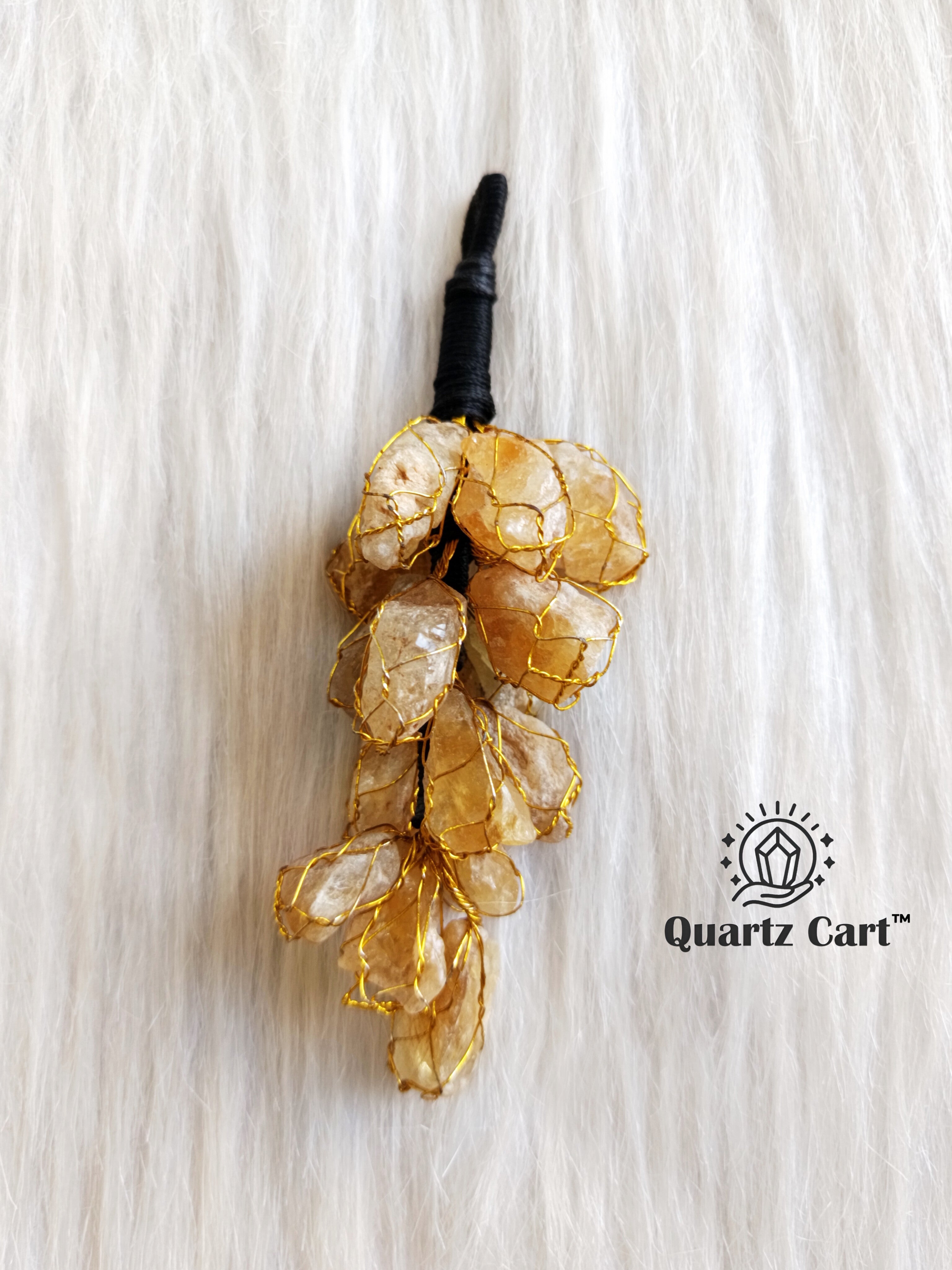 golden stone chip decorative hanging displayed on white background