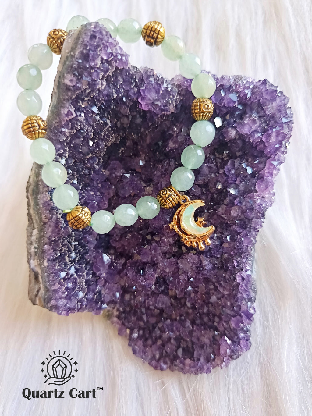 Green Aventurine Charms Bracelet displayed on crystal cluster symbolizing luck and abundance