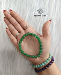Green jade bracelet 8mm held on hand showing natural green gemstone beads, healing crystal bracelet for luck, prosperity and positive energy
