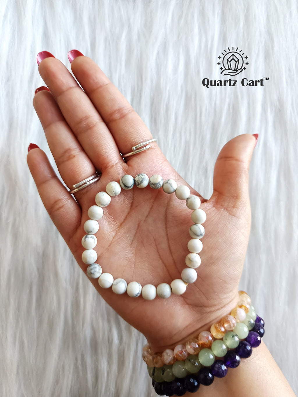 Howlite bracelet held on hand showing natural white gemstone beads, crystal bracelet for calm mind, relaxation and emotional balance