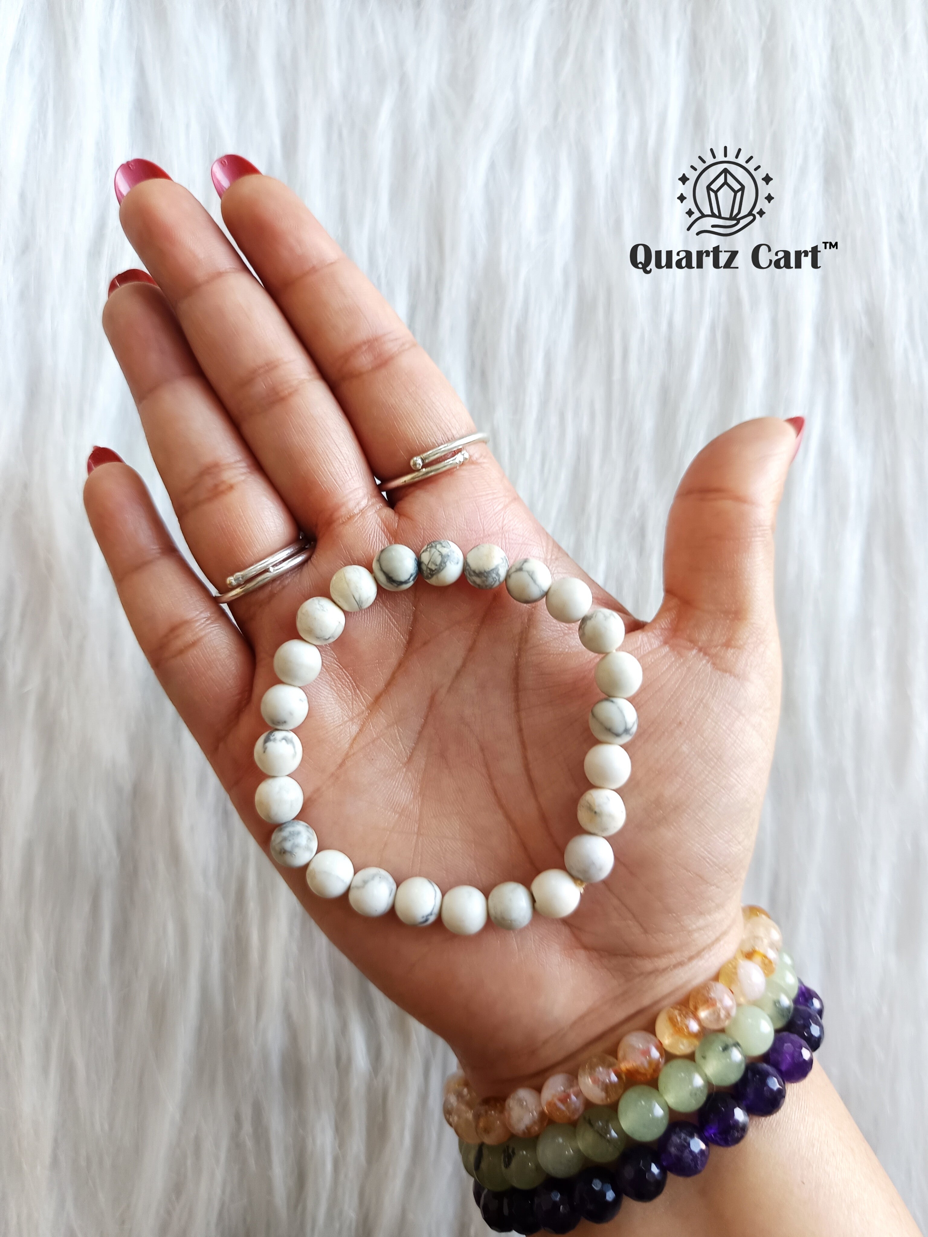 Howlite bracelet held on hand showing natural white gemstone beads, crystal bracelet for calm mind, relaxation and emotional balance