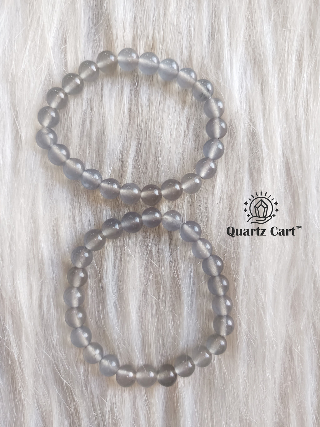 Iolite bracelets displayed on soft surface showing natural violet blue gemstone beads, healing crystal bracelet for intuition and mental clarity