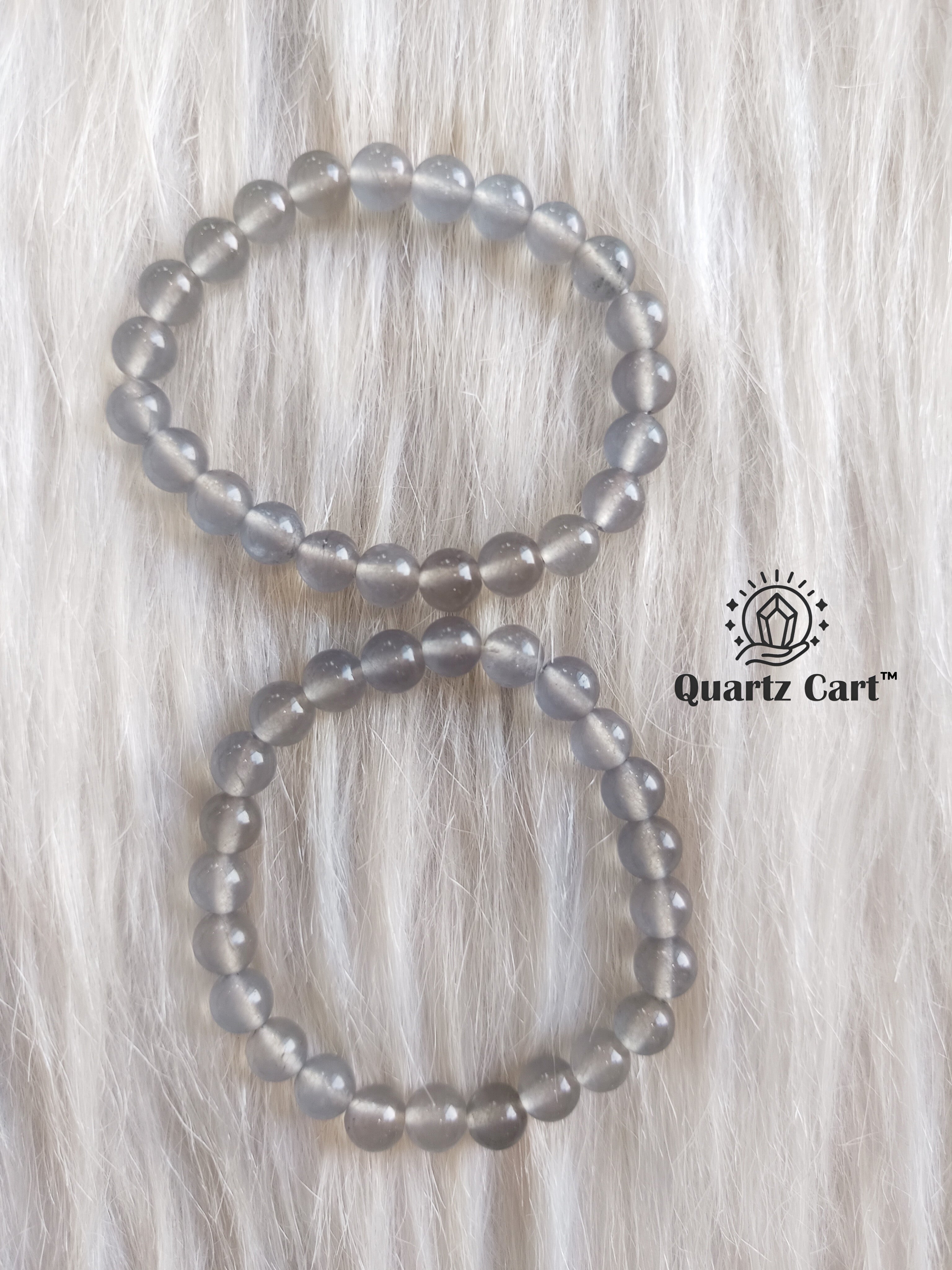 Iolite bracelets displayed on soft surface showing natural violet blue gemstone beads, healing crystal bracelet for intuition and mental clarity