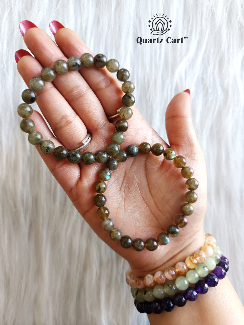 Hand holding Labradorite healing crystal bracelet for spiritual protection and intuition