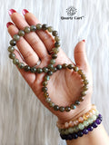 Hand holding Labradorite healing crystal bracelet for spiritual protection and intuition