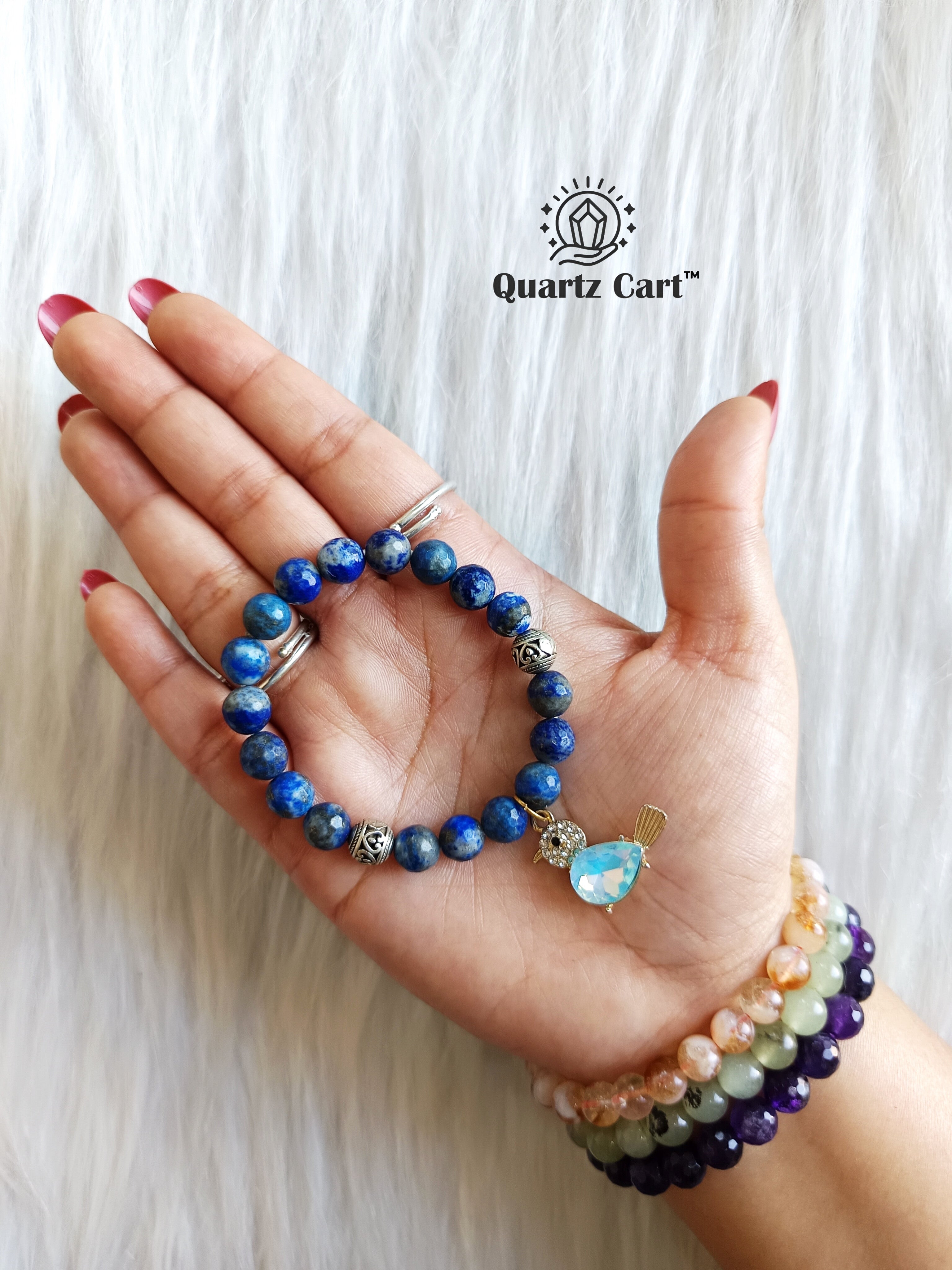 Lapis lazuli faceted charms bracelet held on hand showing natural blue gemstone beads, healing crystal bracelet for clarity and confidence