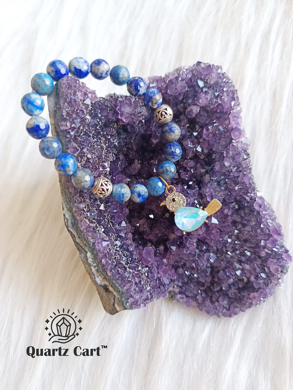 Lapis lazuli faceted charms bracelet placed on crystal cluster showing deep blue gemstone beads, healing crystal bracelet for wisdom and clarity