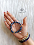 Hand wearing Lapis Lazuli charms kids bracelet for confidence focus and communication