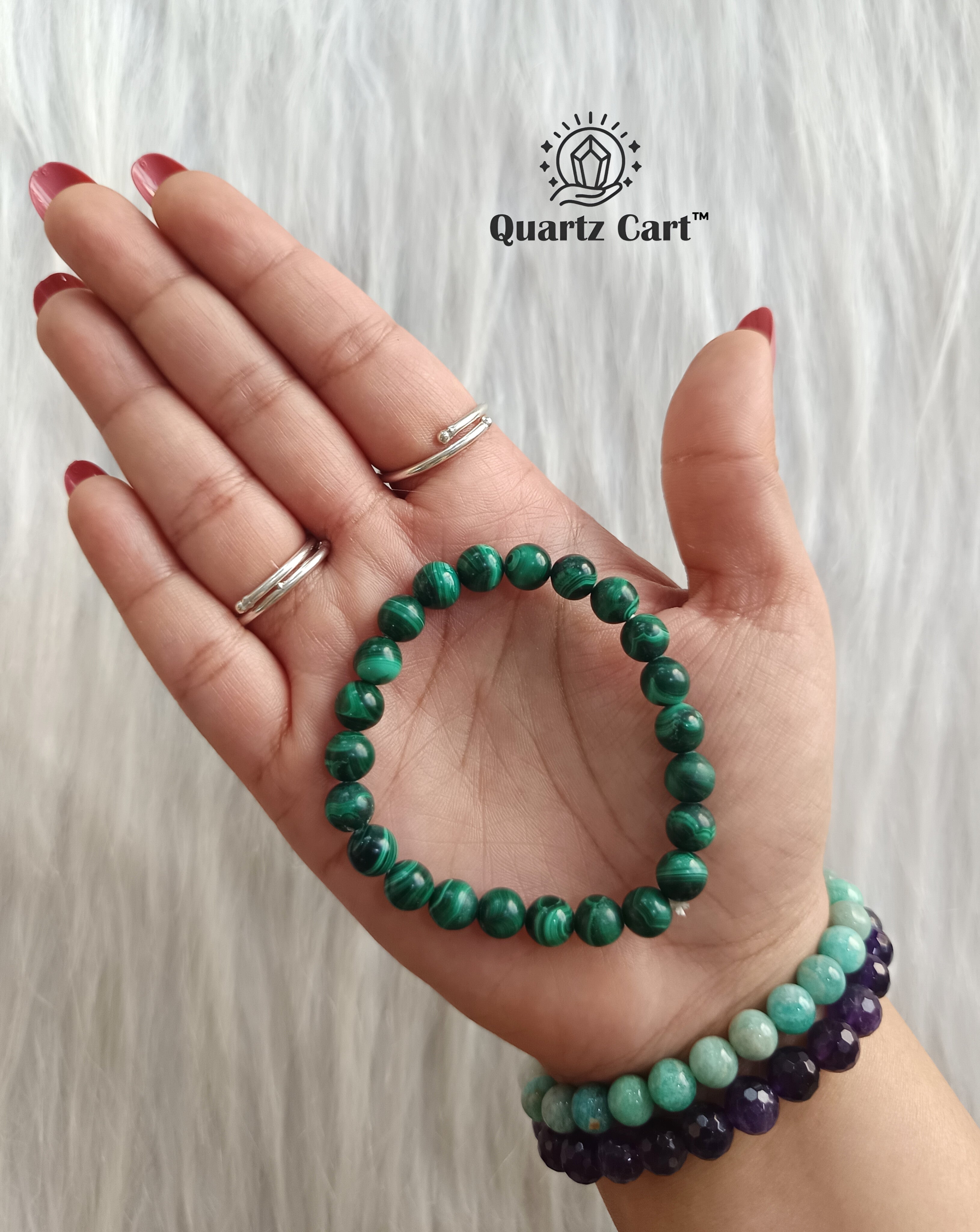 Malachite bracelet held on hand showing natural green gemstone beads, crystal bracelet for protection, emotional healing and positive energy