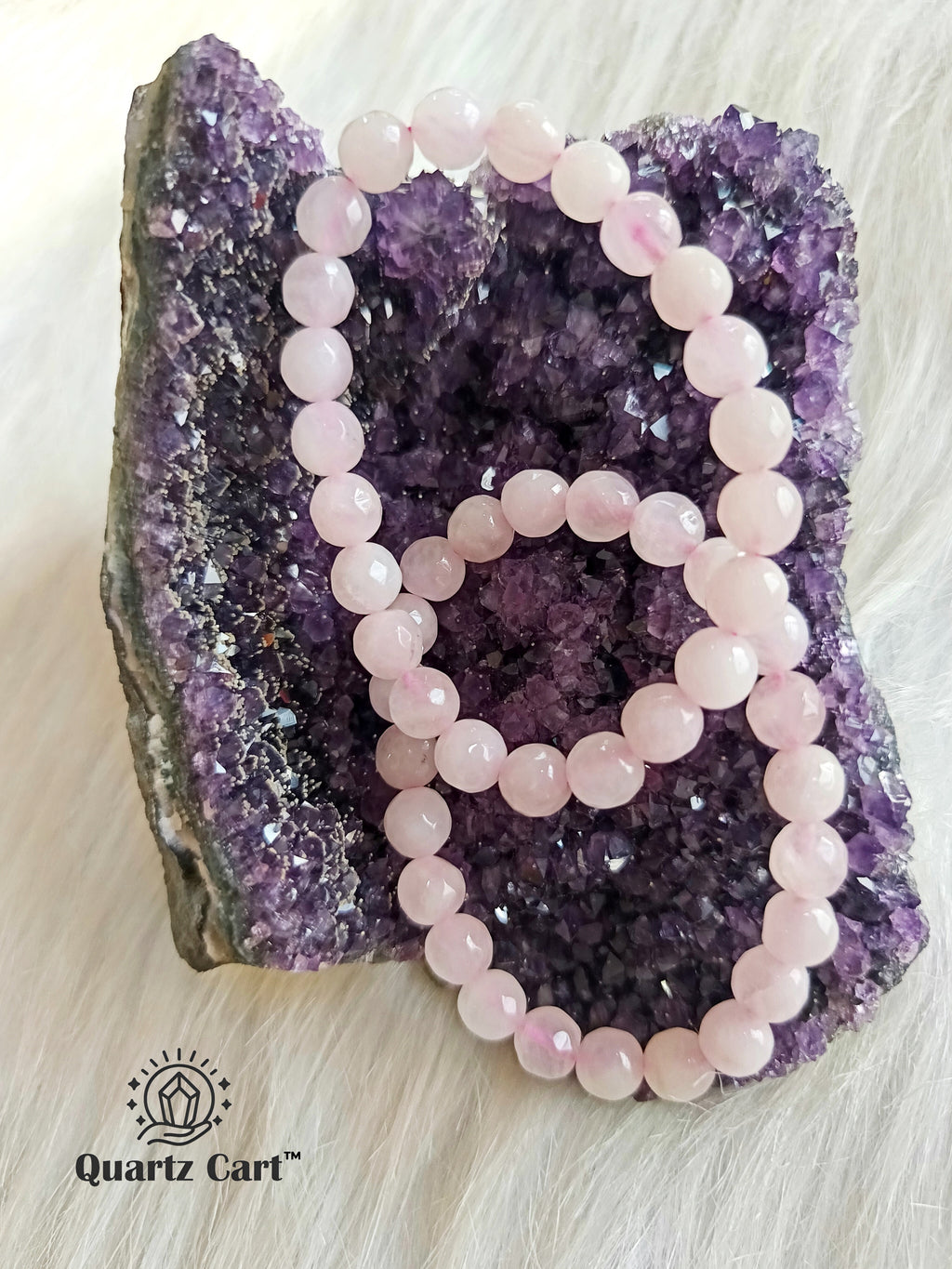 Natural Rose Quartz faceted gemstone bracelet displayed on crystal cluster for love harmony and emotional healing