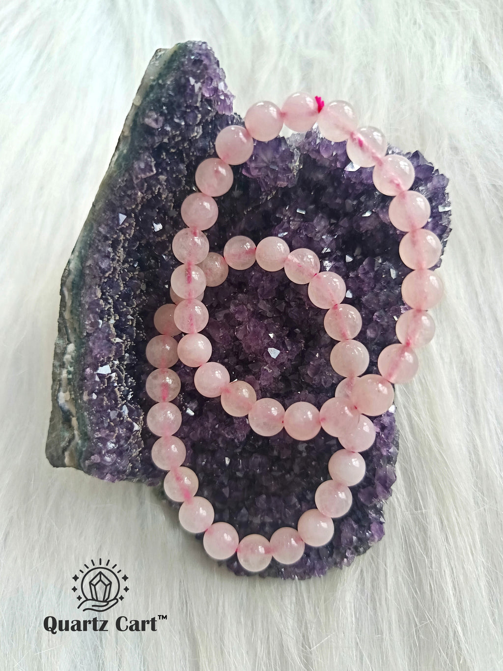 Natural Rose Quartz gemstone bracelets displayed on crystal cluster symbolizing love compassion and harmony