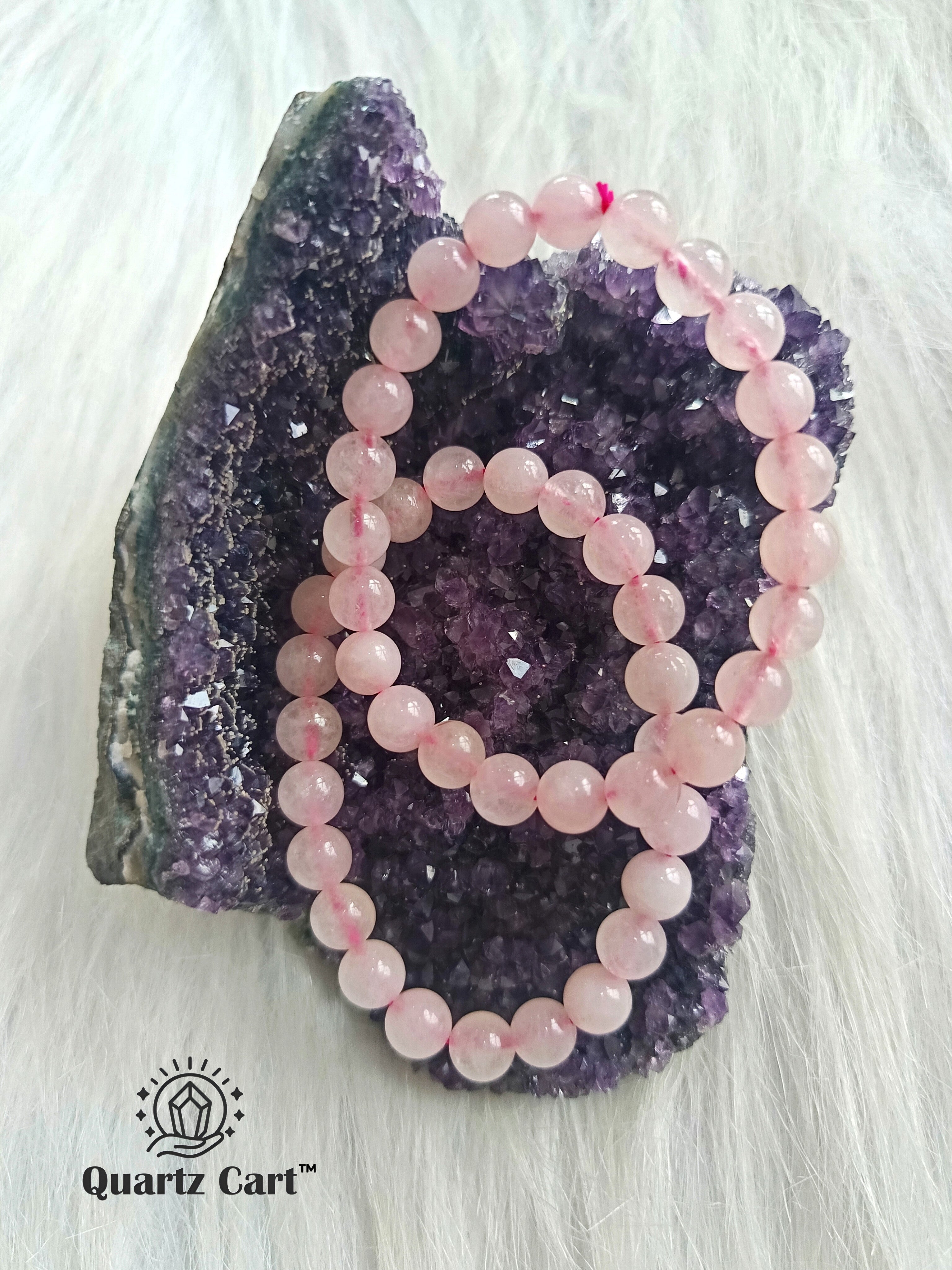 Natural Rose Quartz gemstone bracelets displayed on crystal cluster symbolizing love compassion and harmony