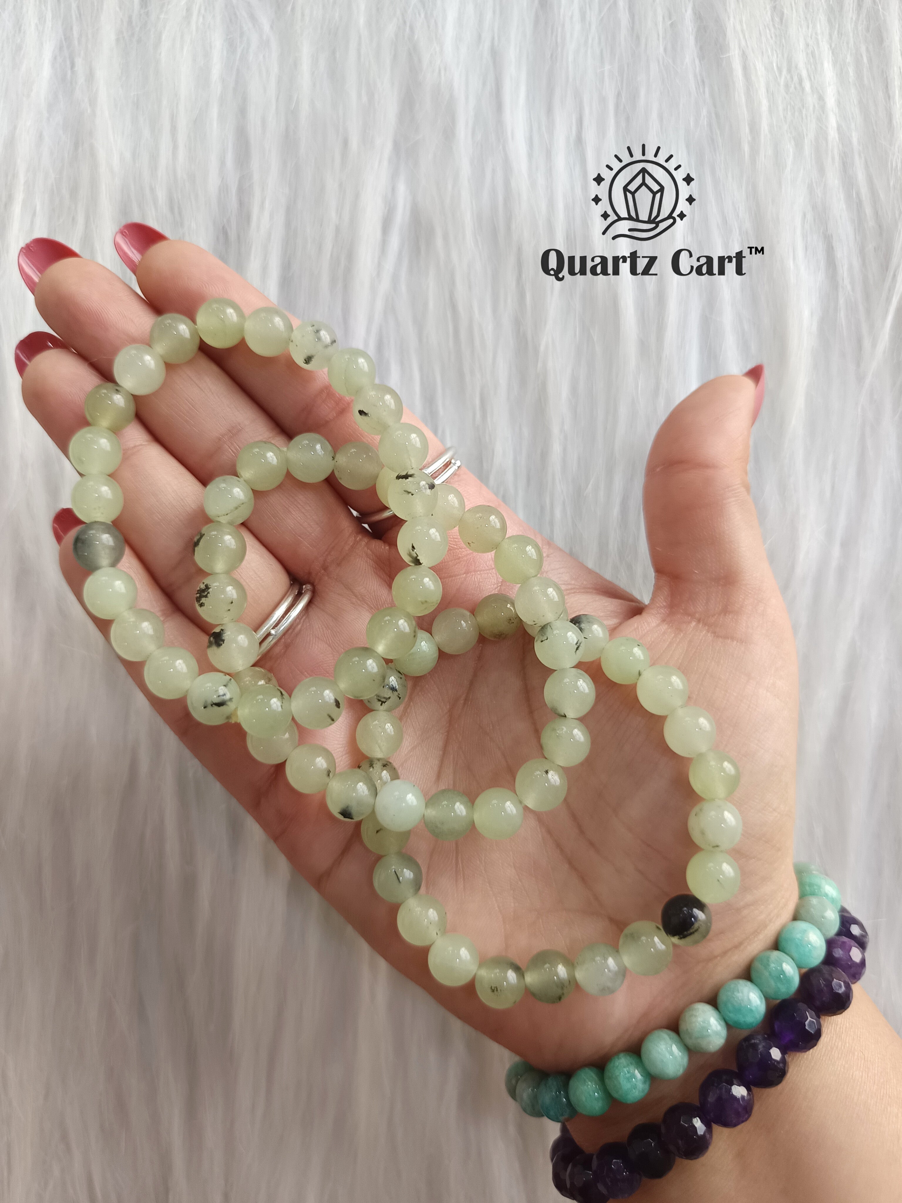 Hand holding Prehnite healing crystal bracelet for inner peace intuition and emotional balance
