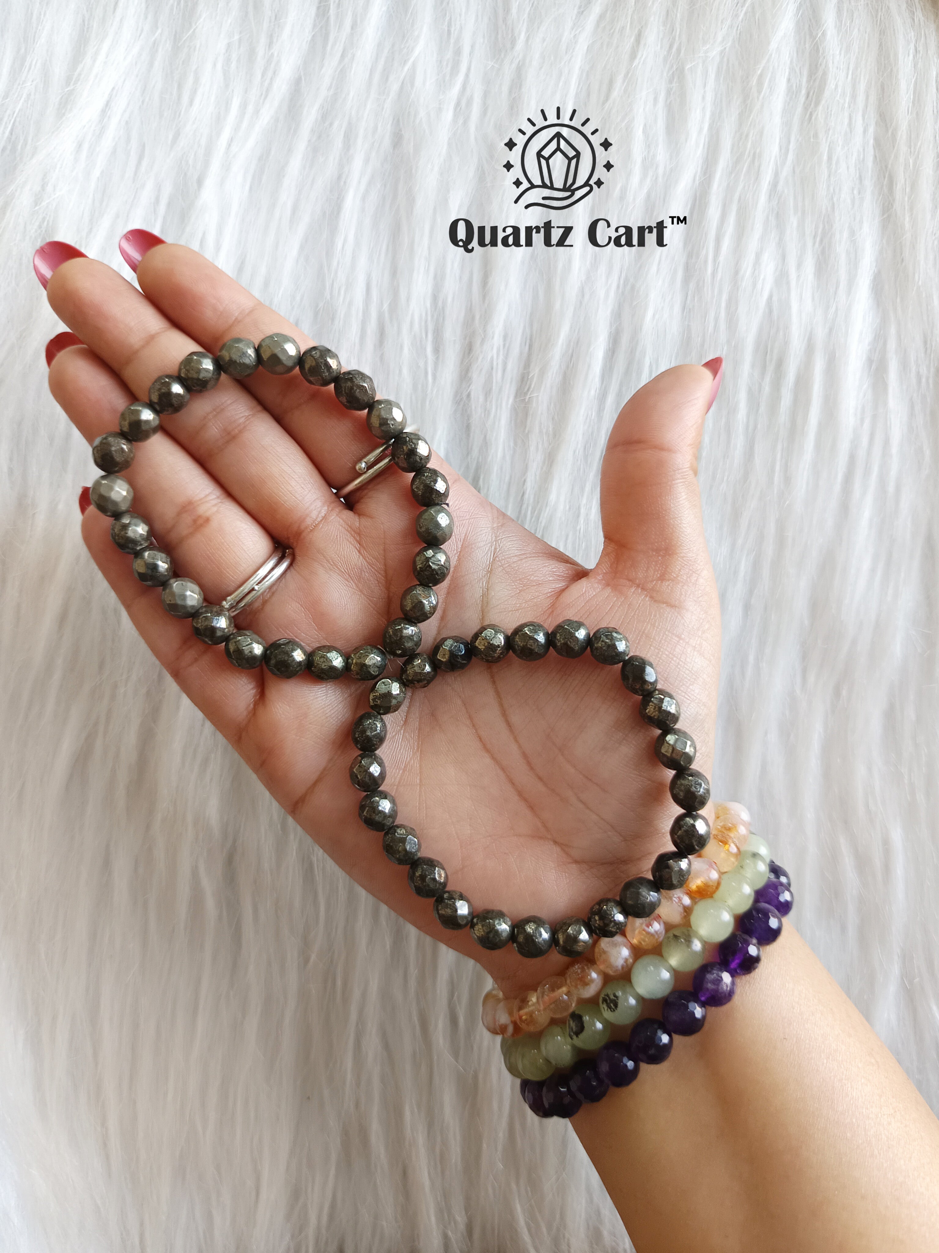 Hand holding Pyrite faceted healing crystal bracelet for wealth abundance confidence and protection