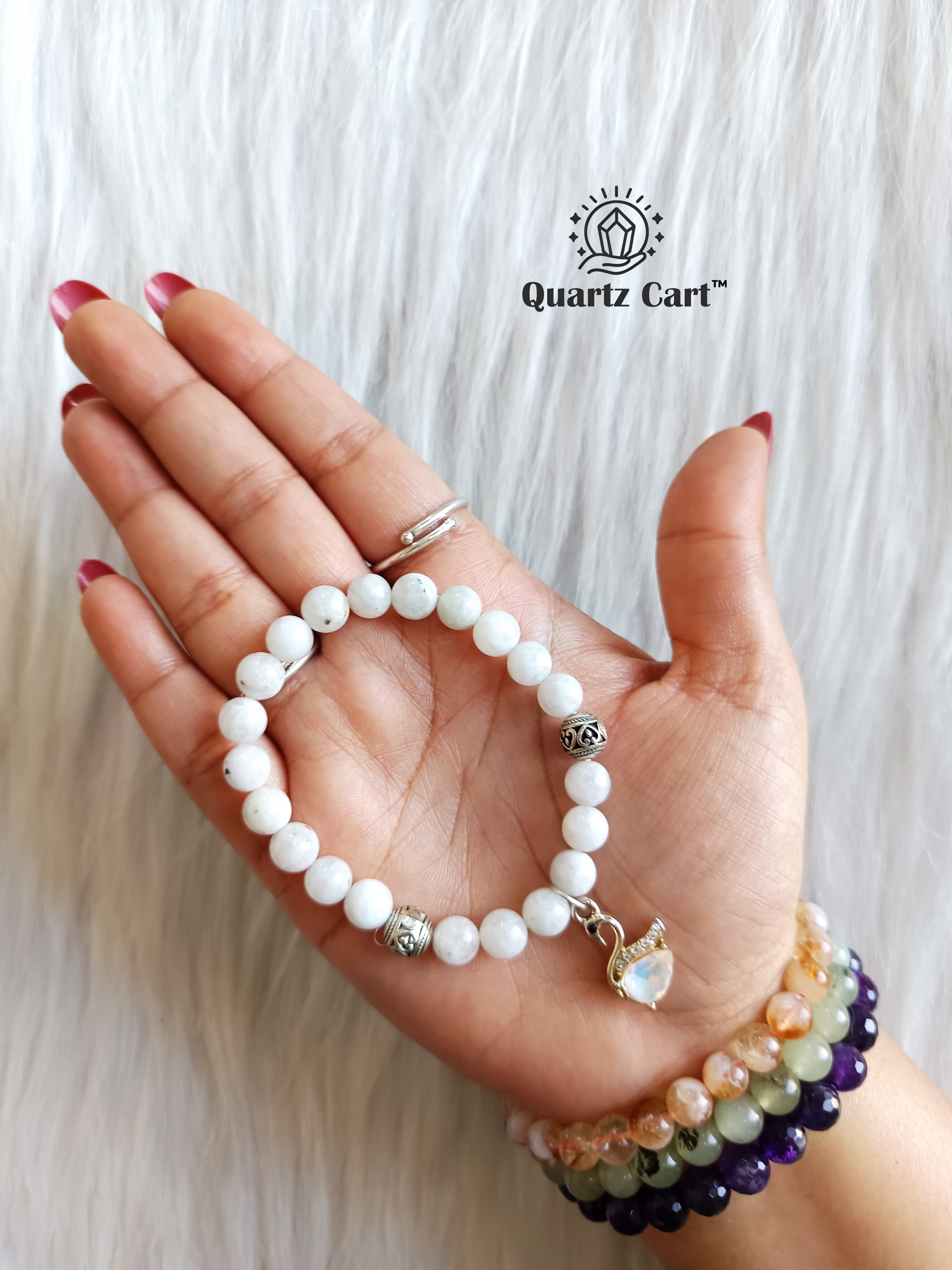 Rainbow moonstone charms bracelet held on hand showing natural moonstone beads with charm, crystal bracelet for intuition, calmness and emotional healing