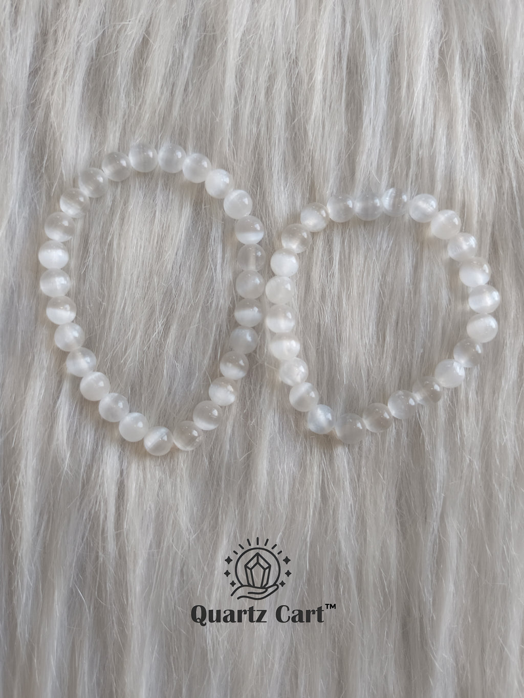 Two selenite crystal bracelets on soft surface showing milky white gemstone beads, spiritual bracelet for peace, clarity and aura cleansing