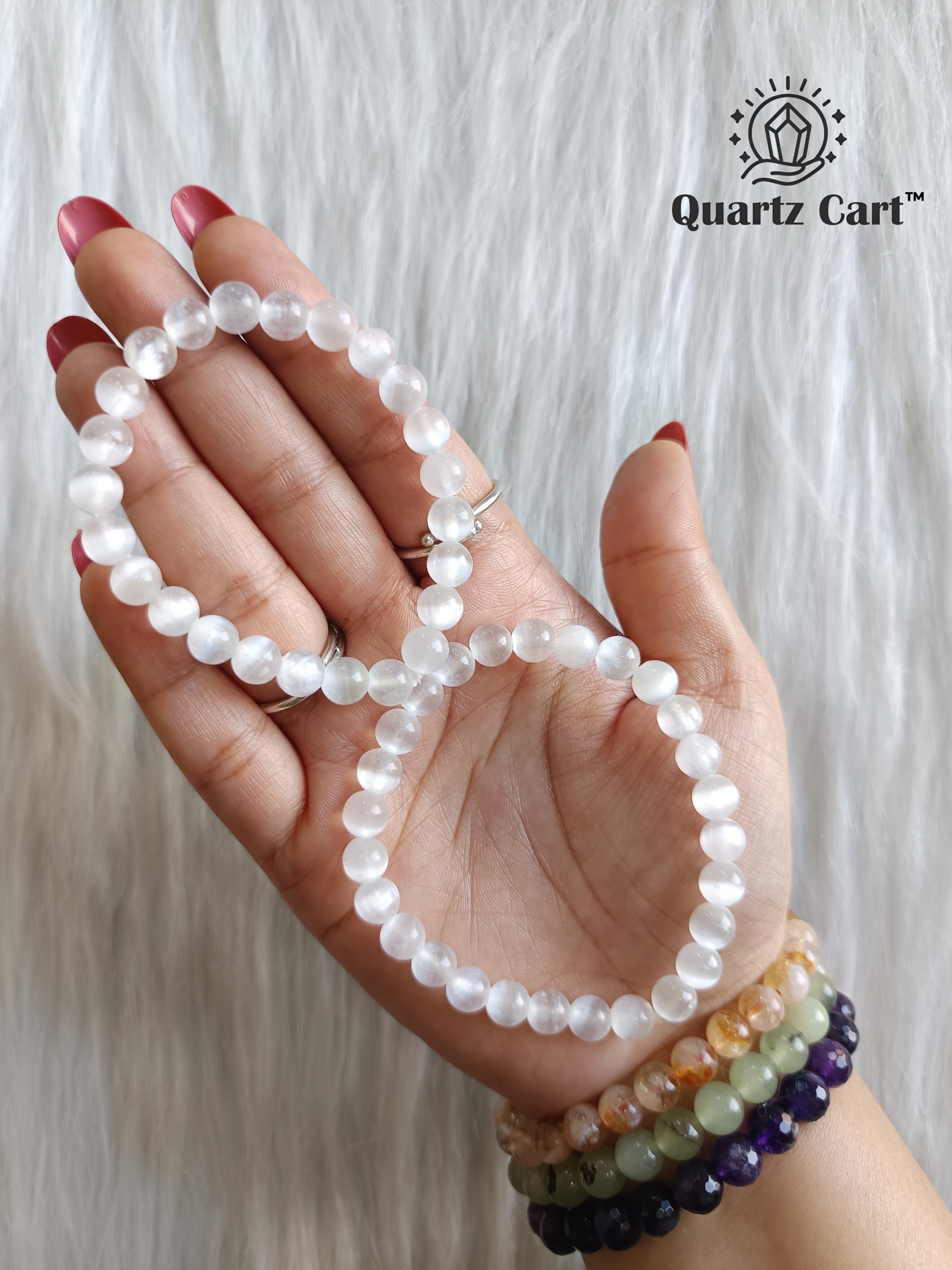 Two selenite bracelets worn on hand displaying natural crystal beads, healing bracelet for stress relief, energy cleansing and spiritual growth