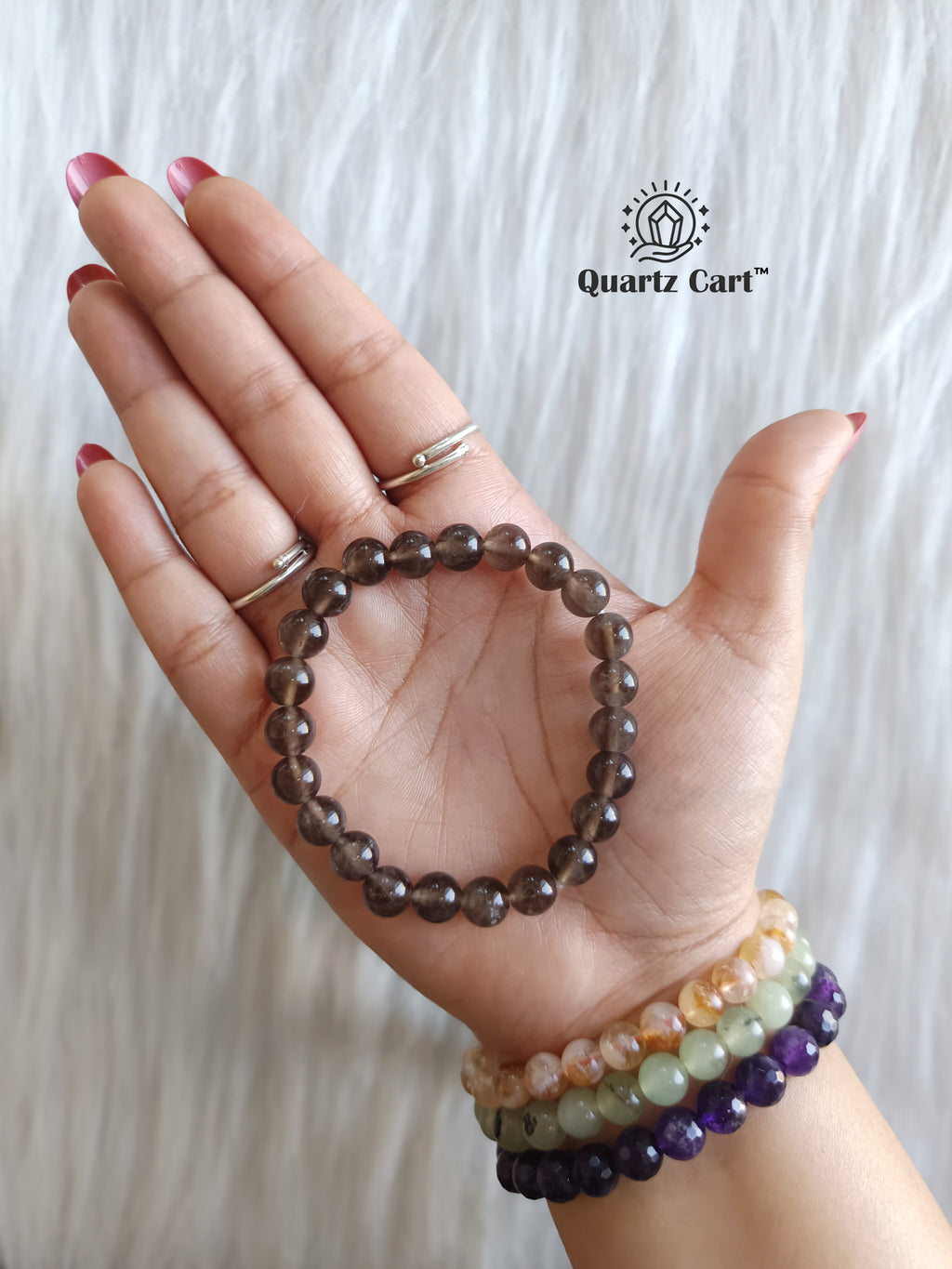 Smoky quartz round bracelet held on hand showing natural brown gemstone beads, healing crystal bracelet for protection, grounding and emotional balance