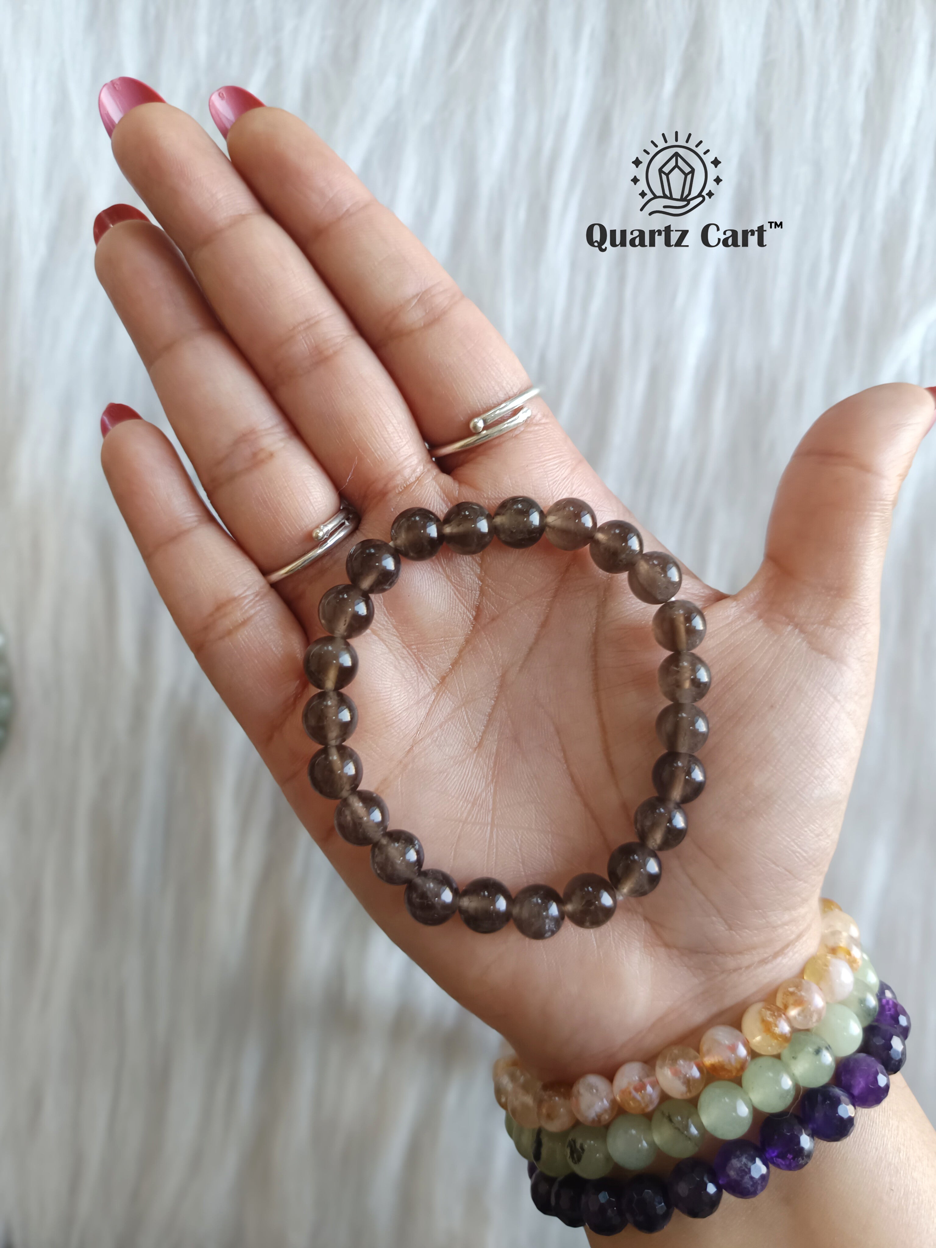 smoky quartz bracelet on hand showing natural brown gemstone beads for stress relief grounding and protection