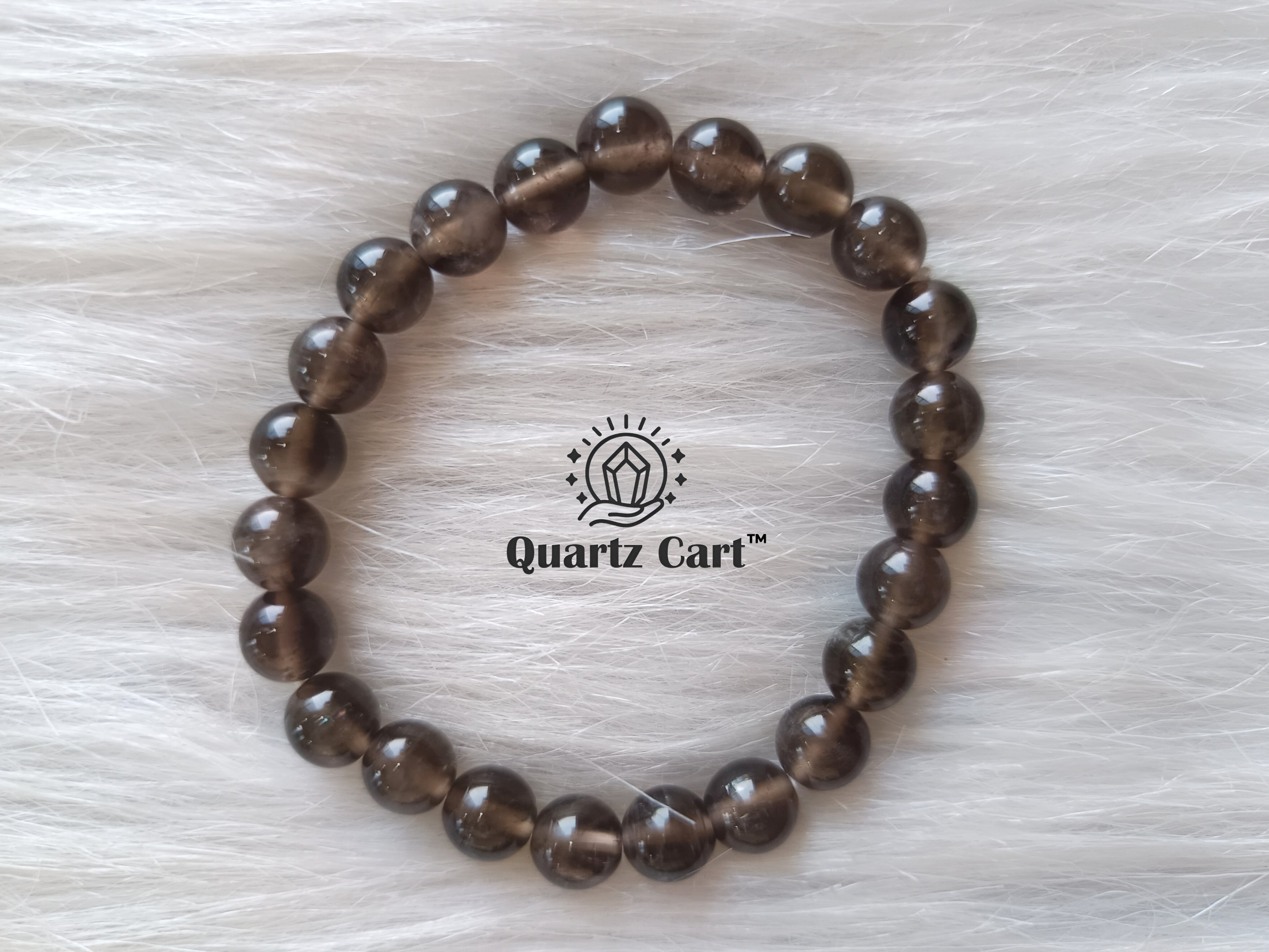 Smoky quartz bracelet displayed on surface with natural brown gemstone beads, crystal bracelet for grounding energy and stress relief